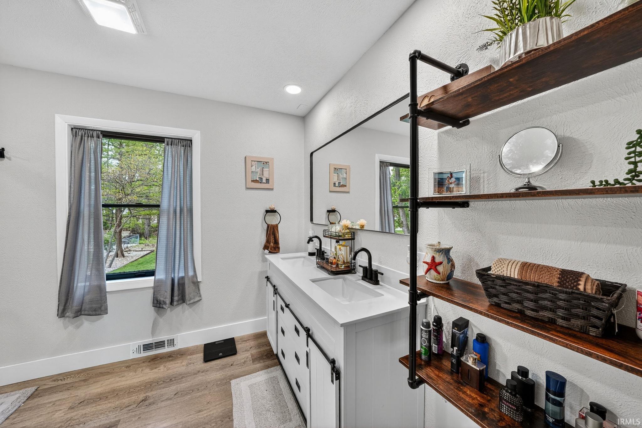 Modern bathroom featuring a dual-sink vanity with a white countertop and matte black faucets