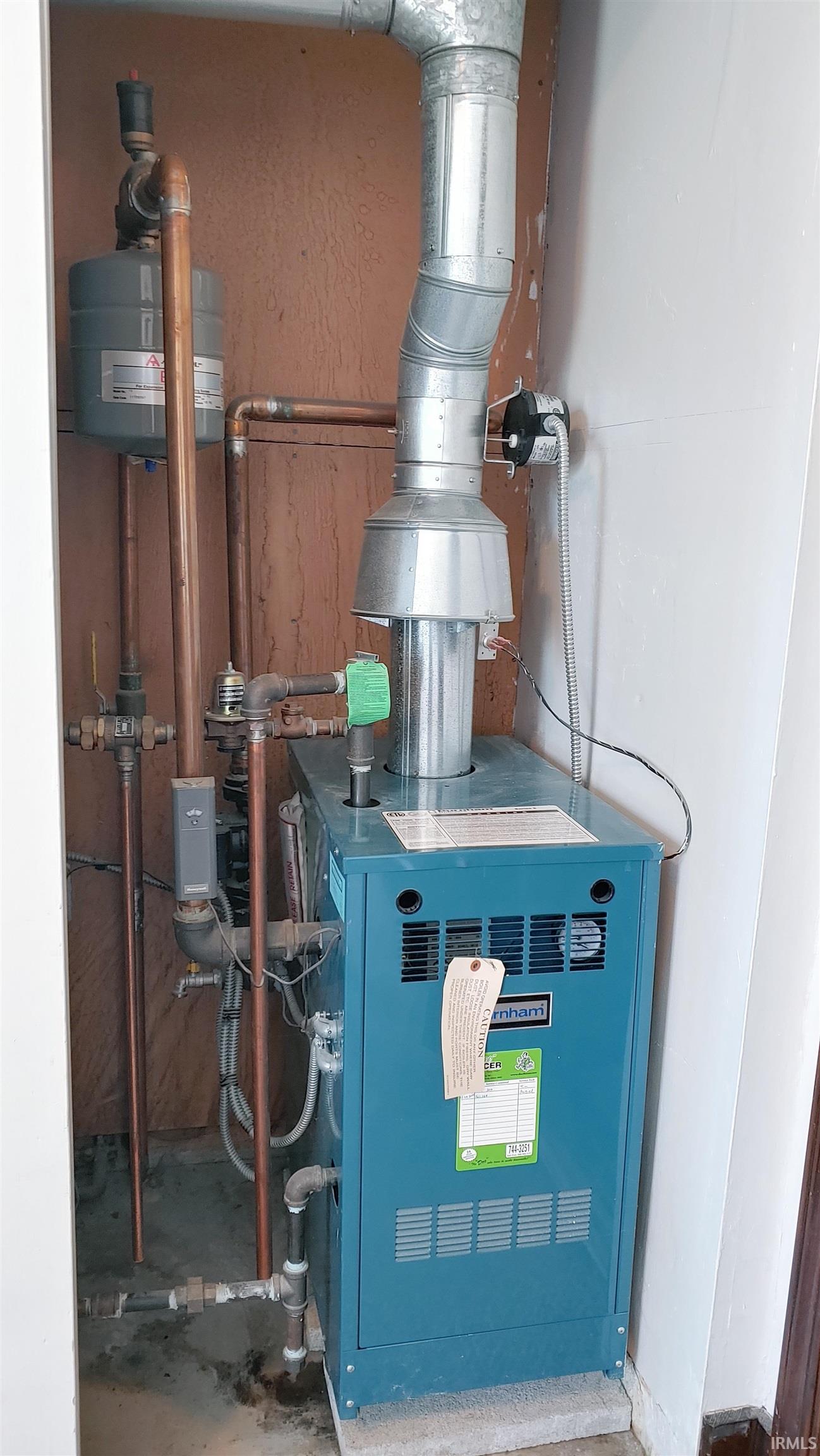 Blue central heating hot water boiler installed in 2004.