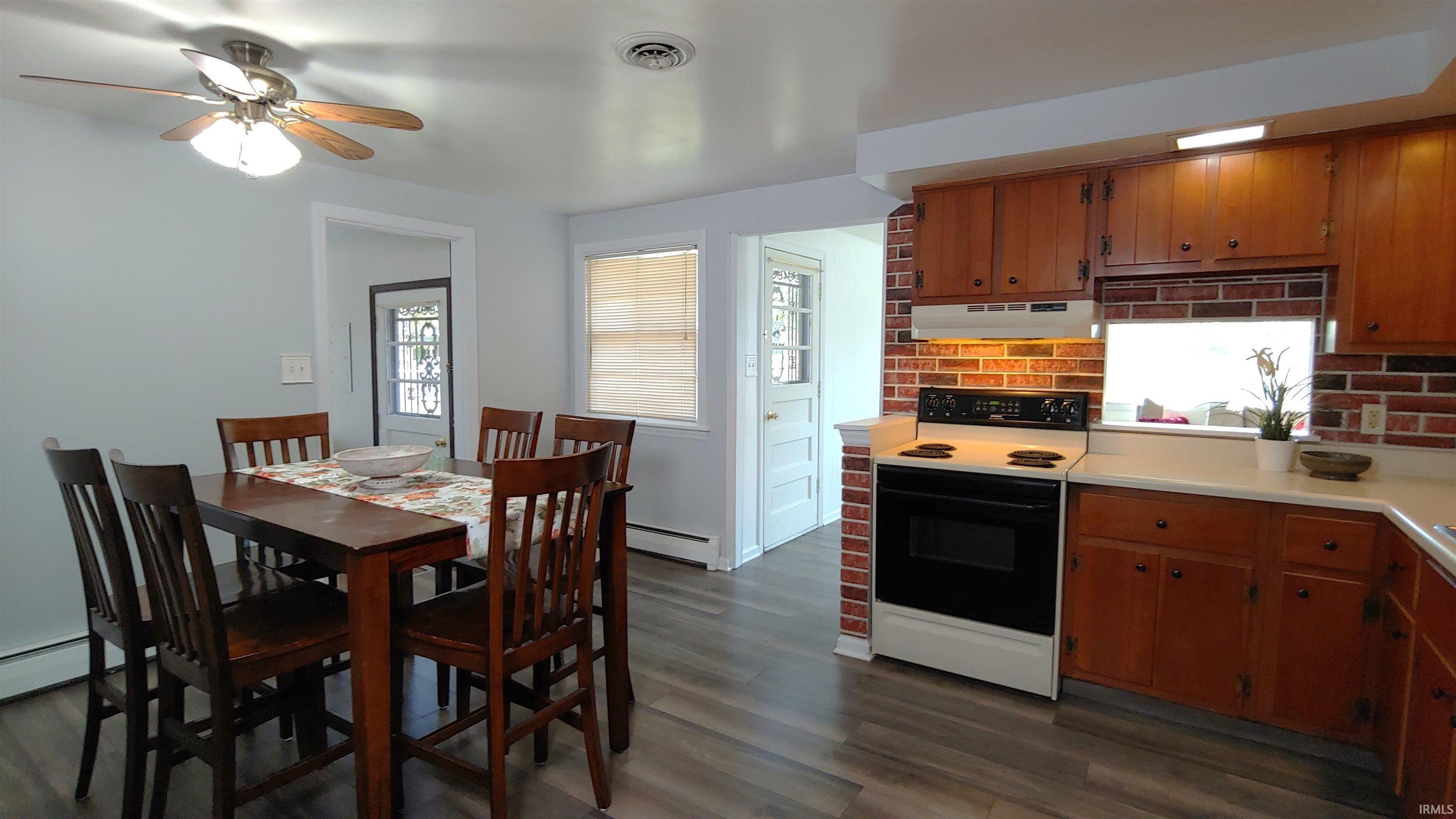 Dining area featuring vinyl plank flooring and is open to kitchen.