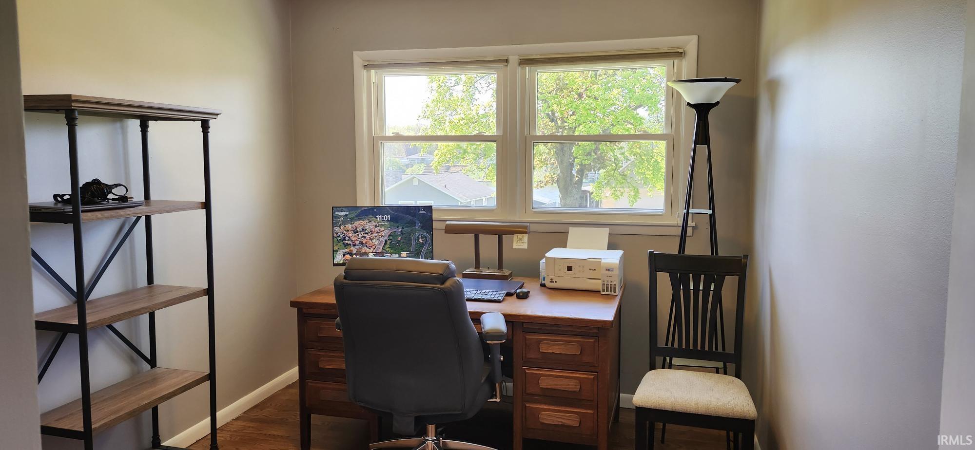 Room featuring neutral wall tones, wood-finish flooring, and a double window with white trim