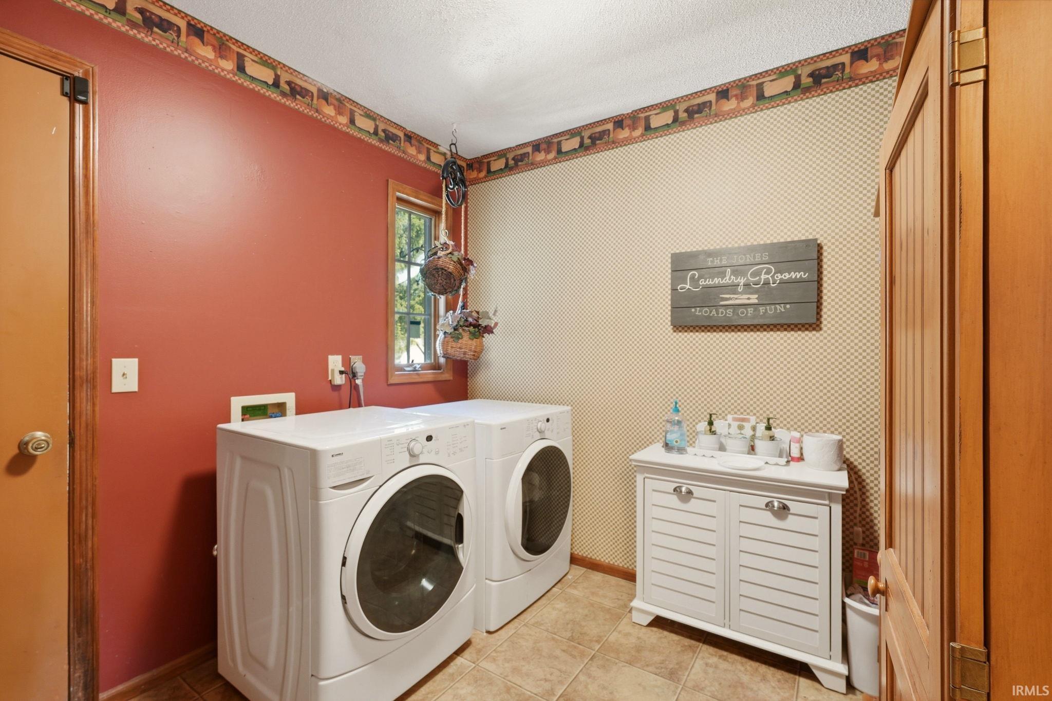 Dedicated laundry area with tiled flooring