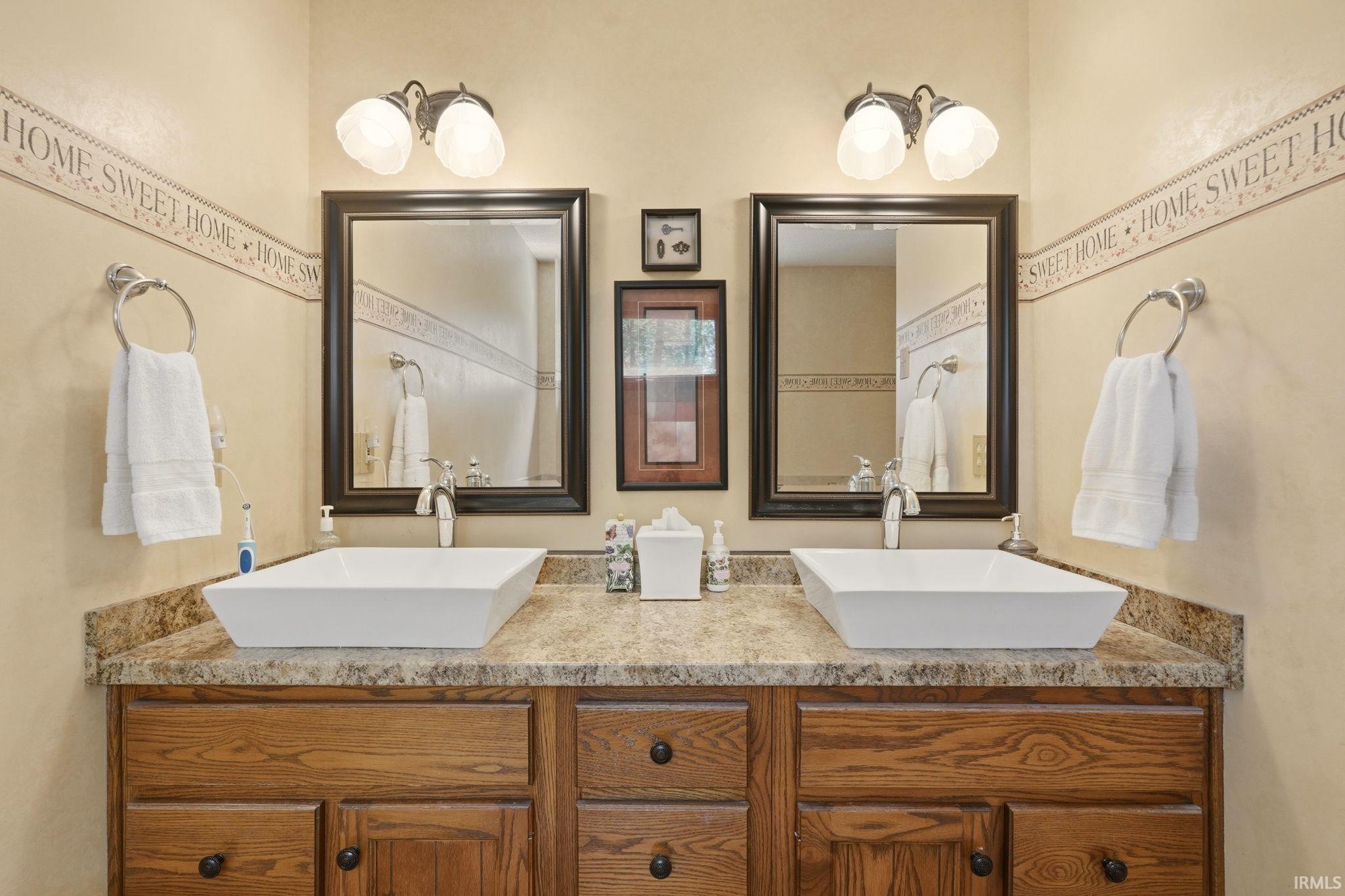 Double vanity with vessel sinks and wood-finish cabinetry