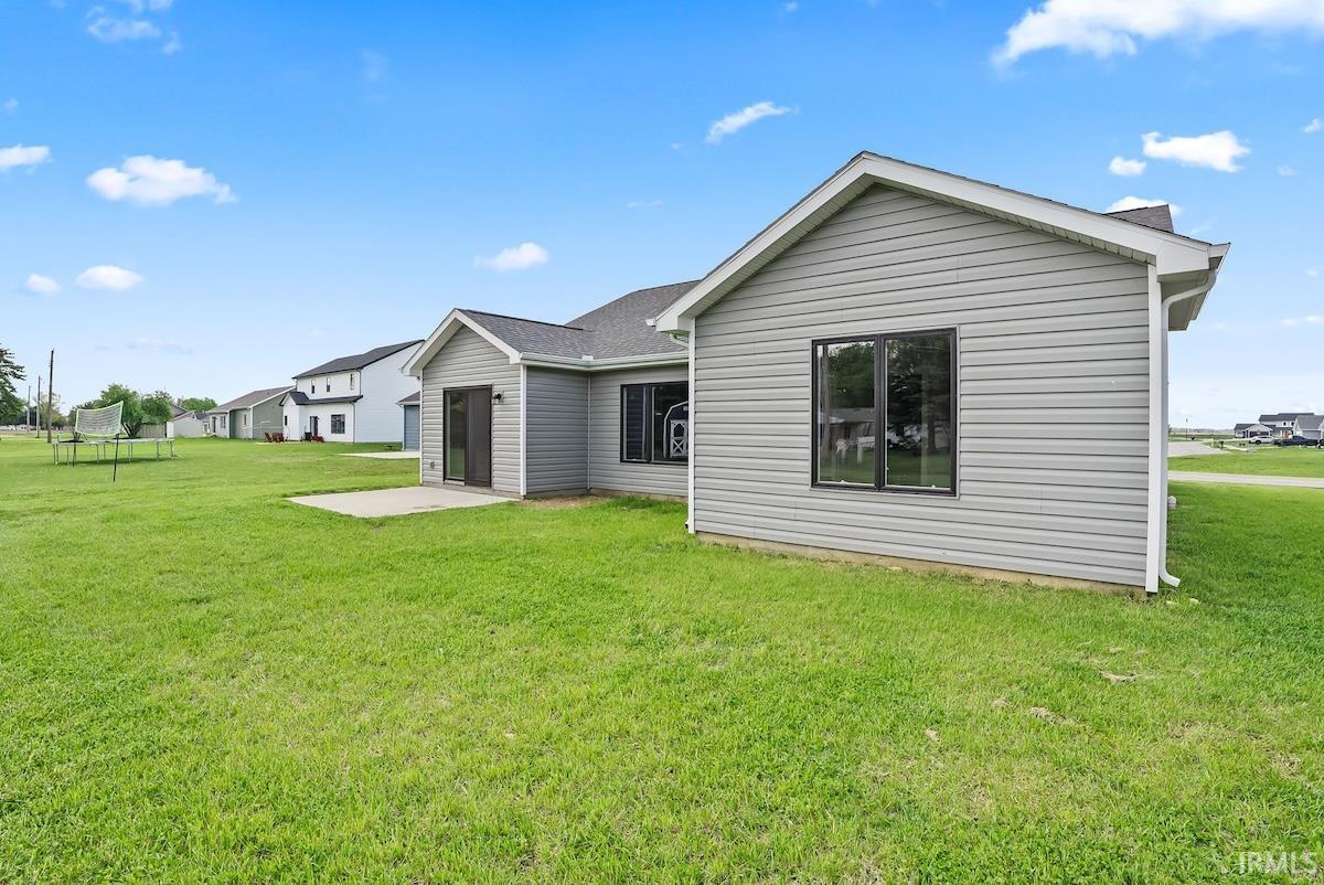 Gray siding exterior with white trim, featuring a dark shingle roof