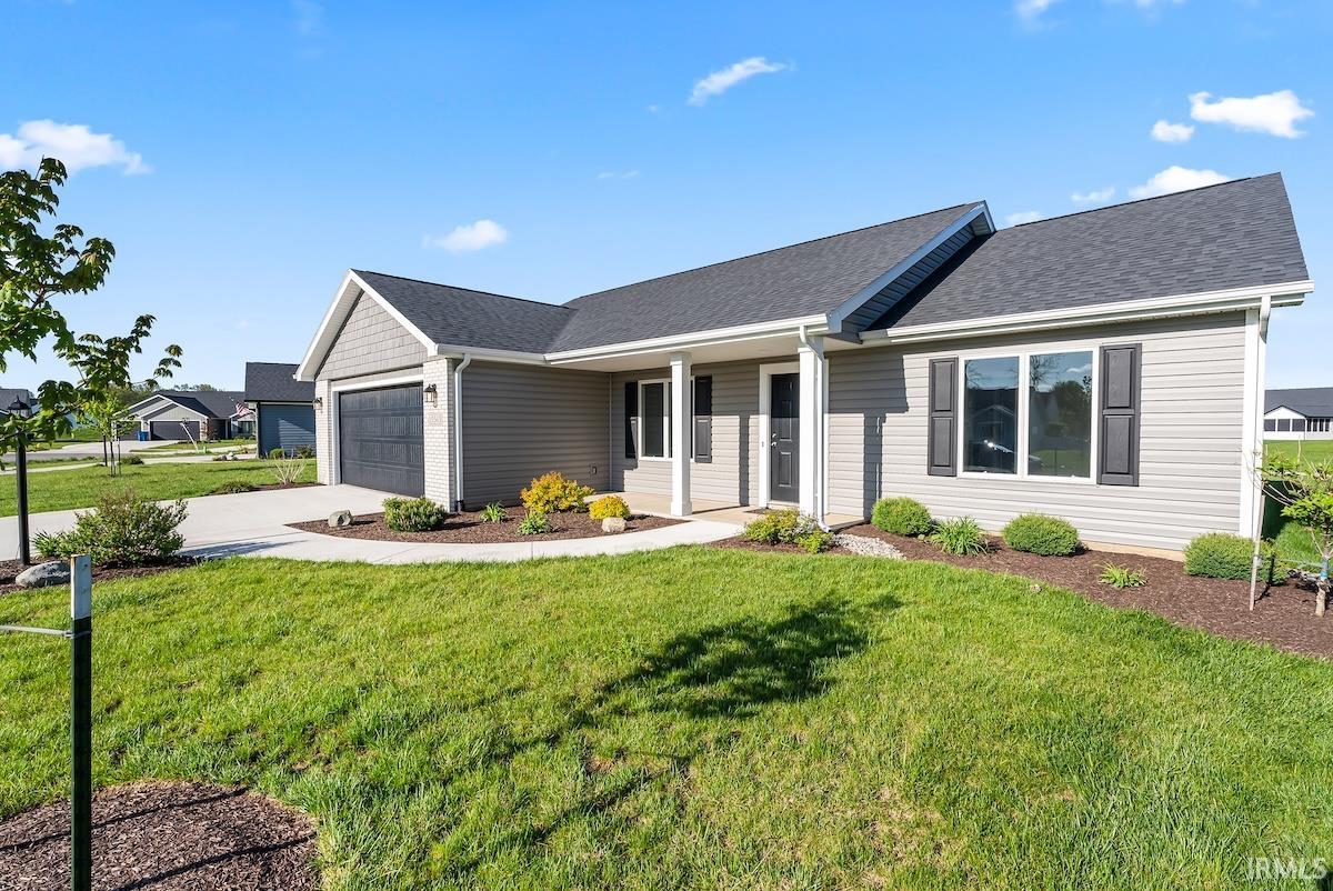 Single-story residence featuring light gray horizontal siding and a dark gray shingle roof
