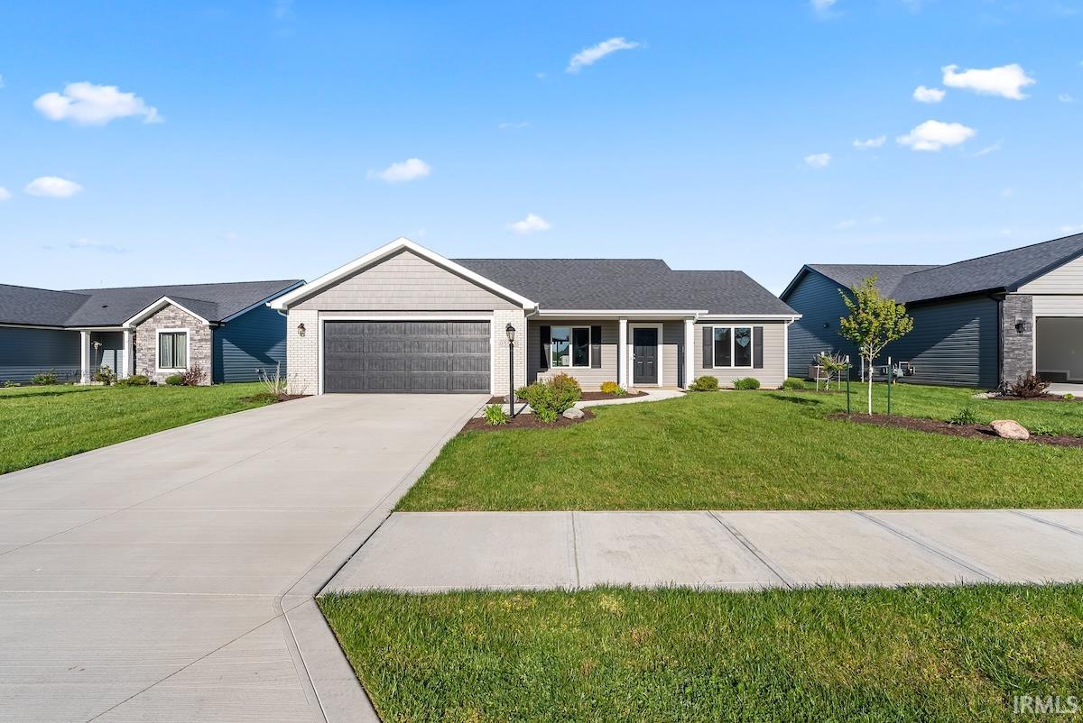 Single-story residence featuring a gray exterior, dark gray garage door, and a covered front entry
