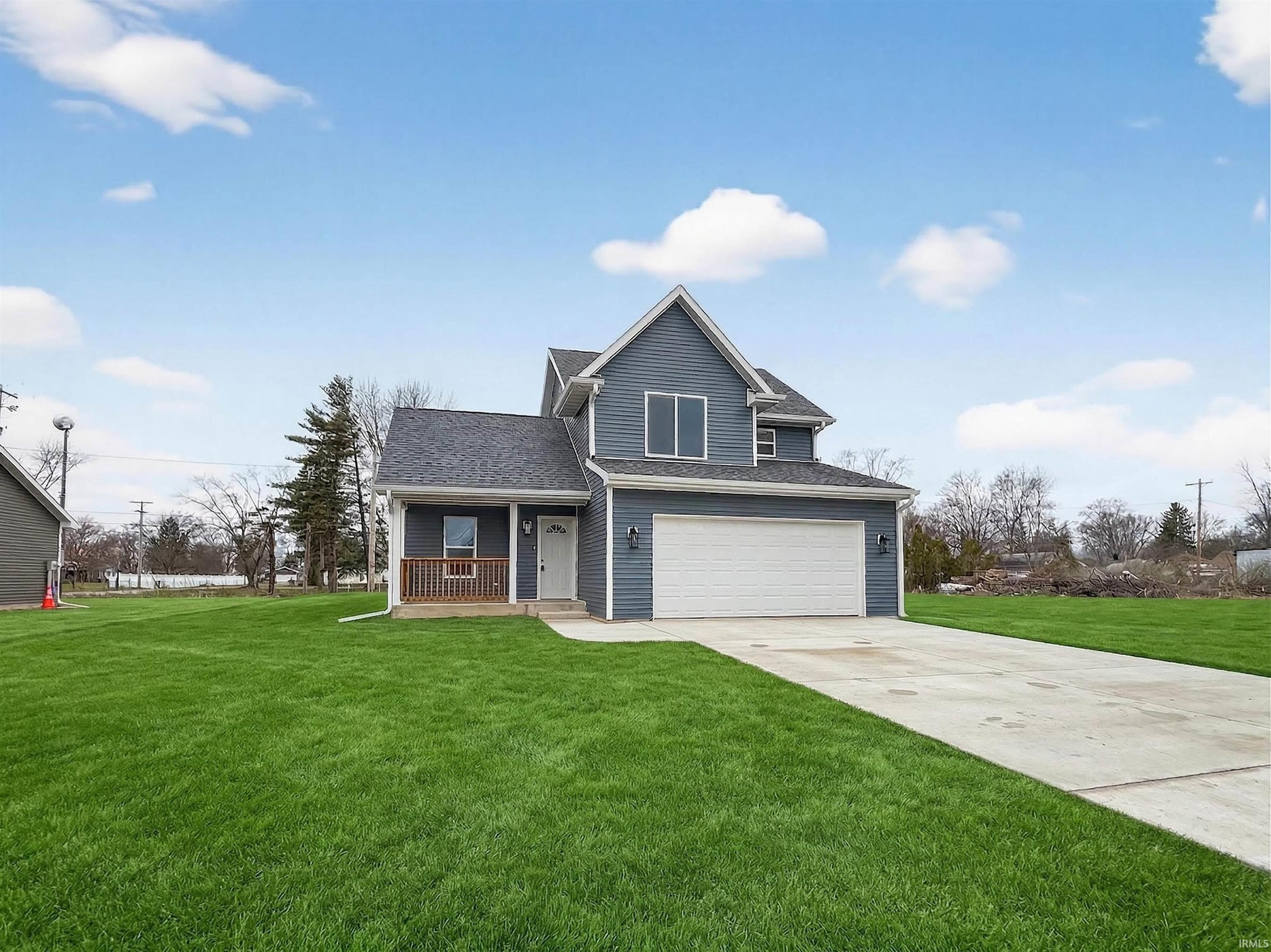 Two-story residence featuring blue siding and white trim