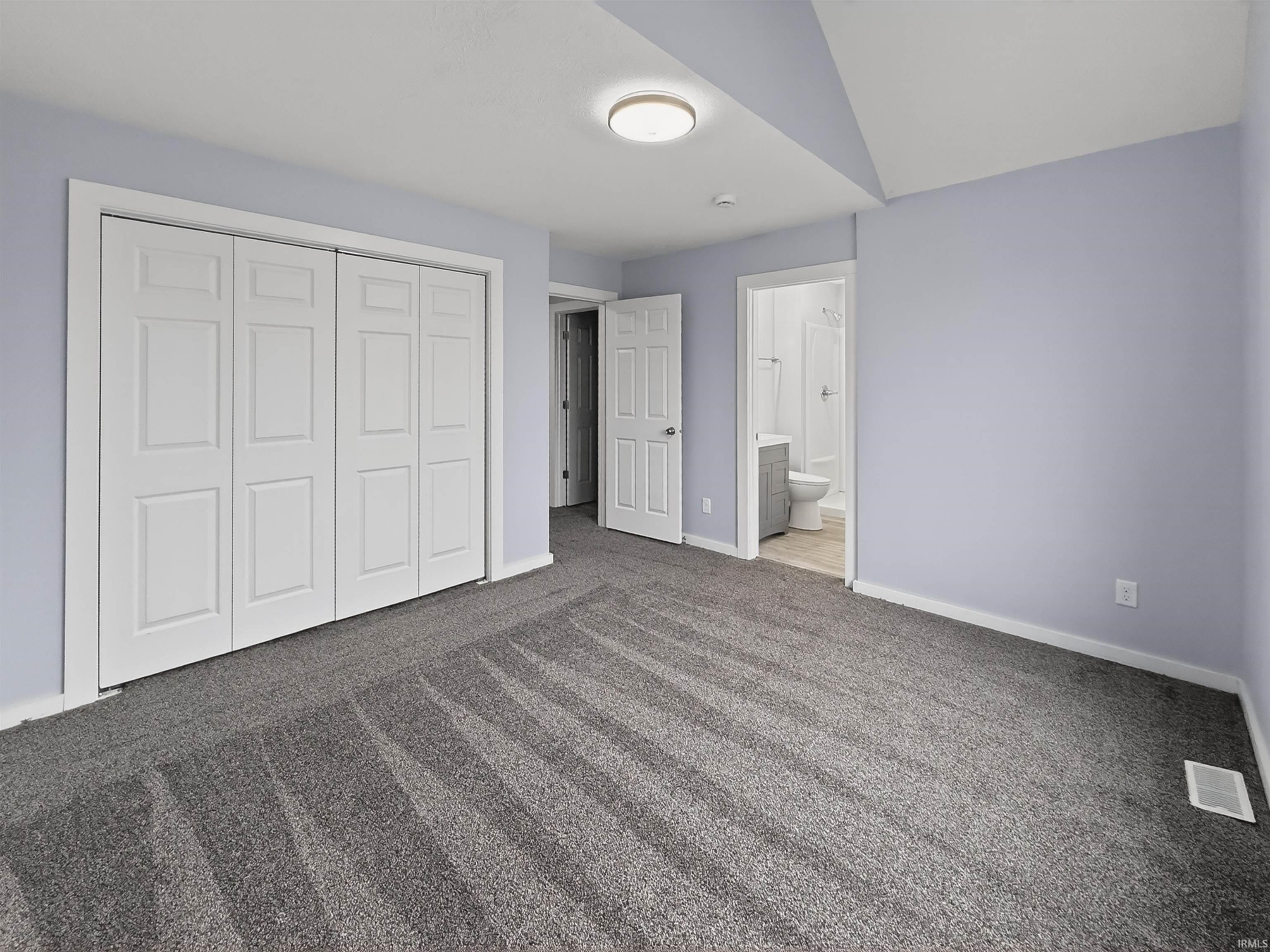 Carpeted room with a patterned gray finish
