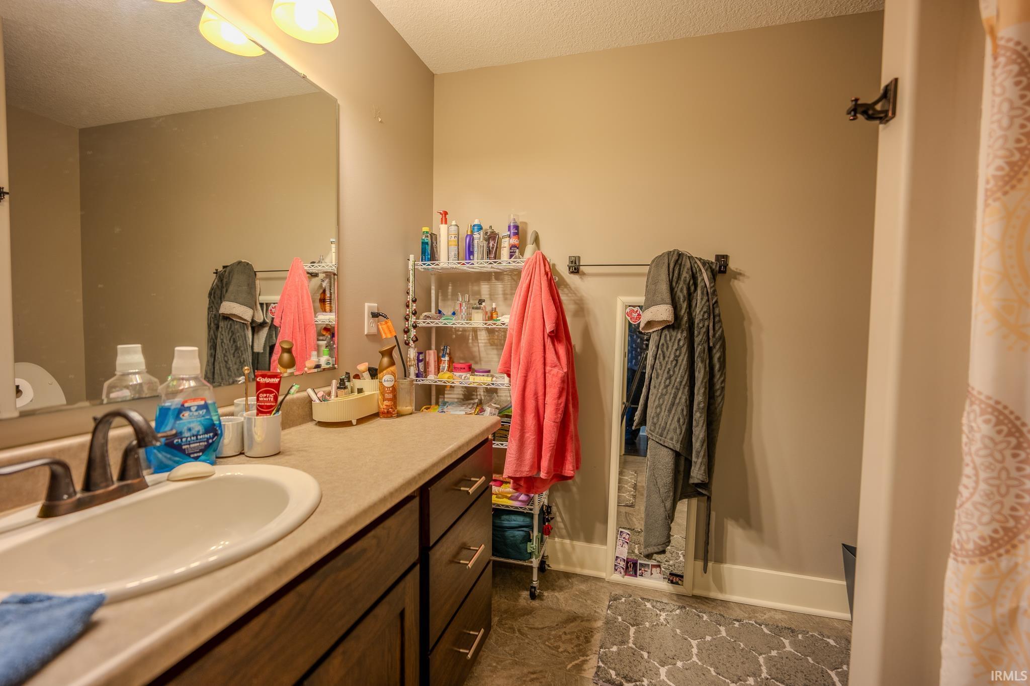 Bathroom vanity with an integrated sink and bronze-finish faucet