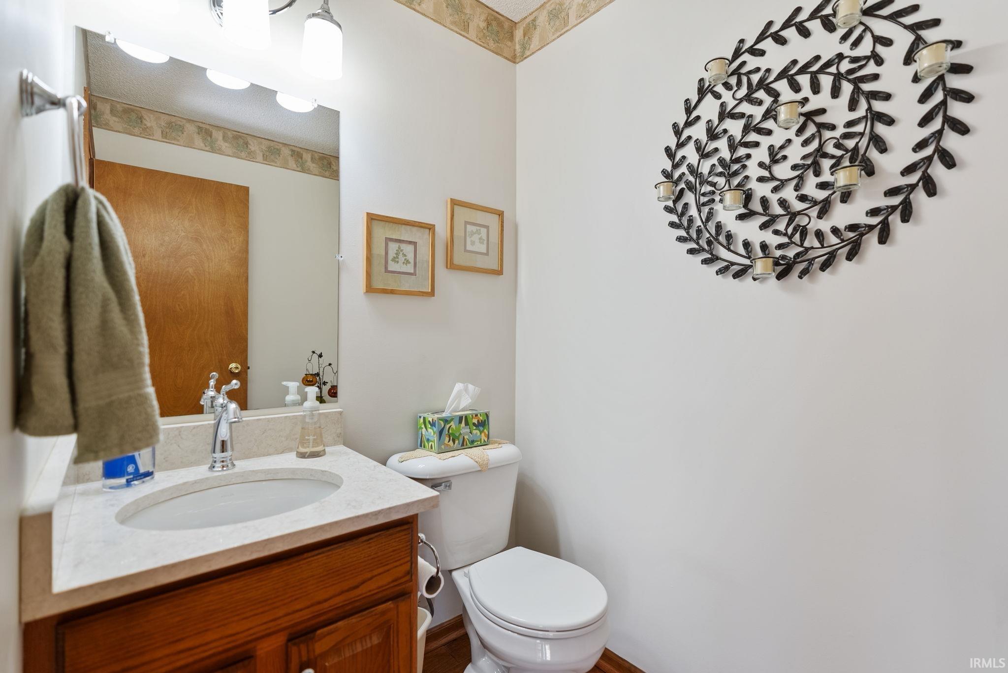 Bathroom vanity with a white oval sink, chrome faucet, and integrated countertop