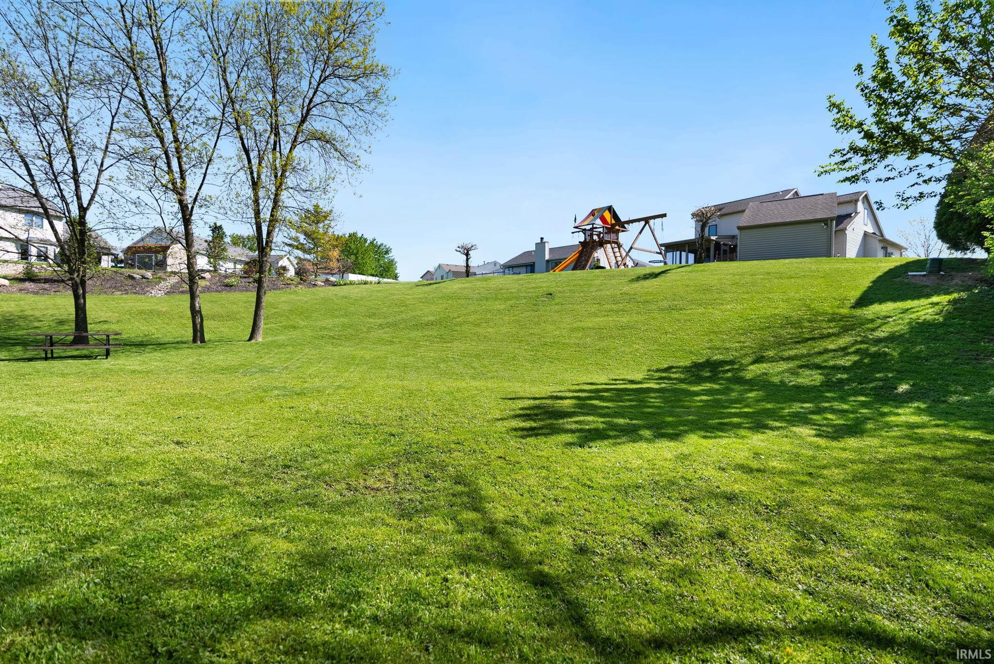 Expansive green lawn with a gentle slope