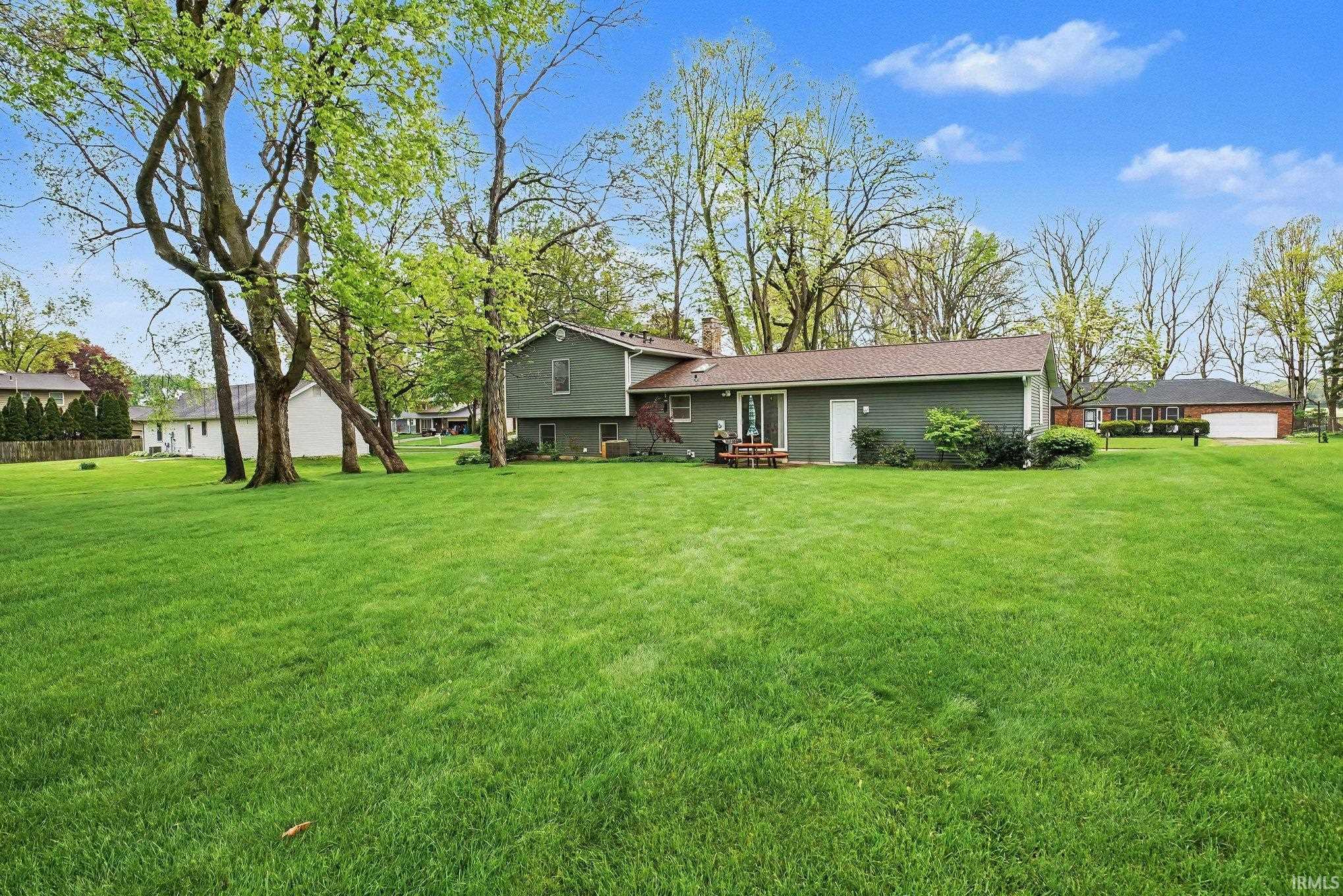 Expansive green lawn with mature trees