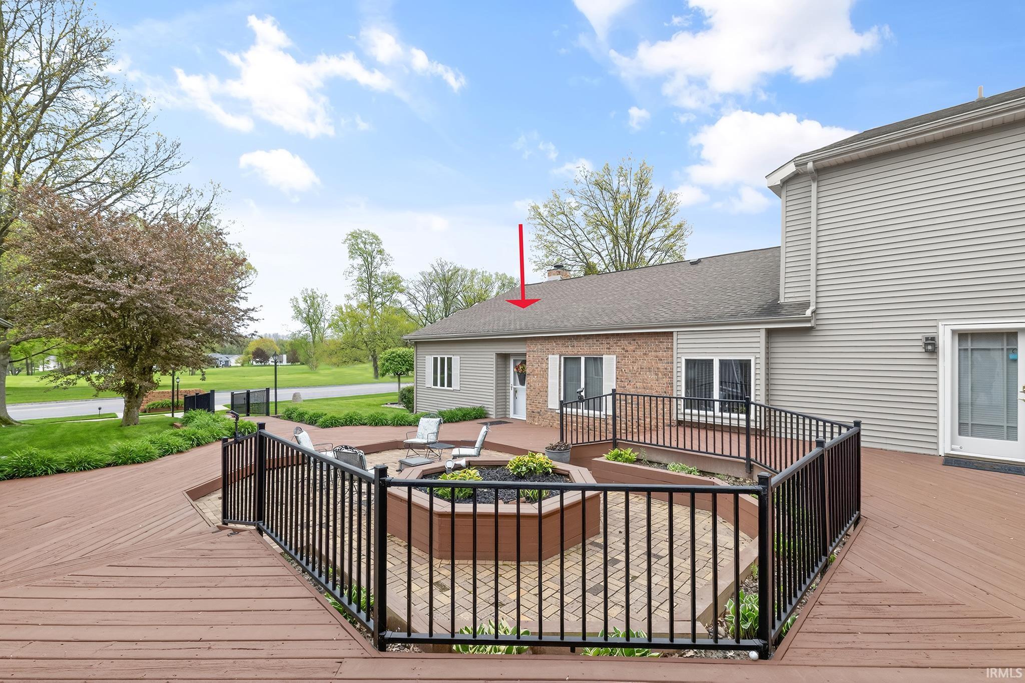 Multi-level wood-finish deck with black metal railings
