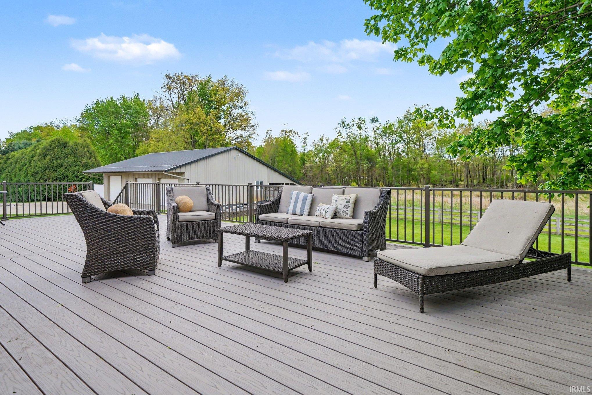 Spacious back porch was just redone and ready for entertaining or sitting out and enjoying all of the natural beauty and wildlife of this property