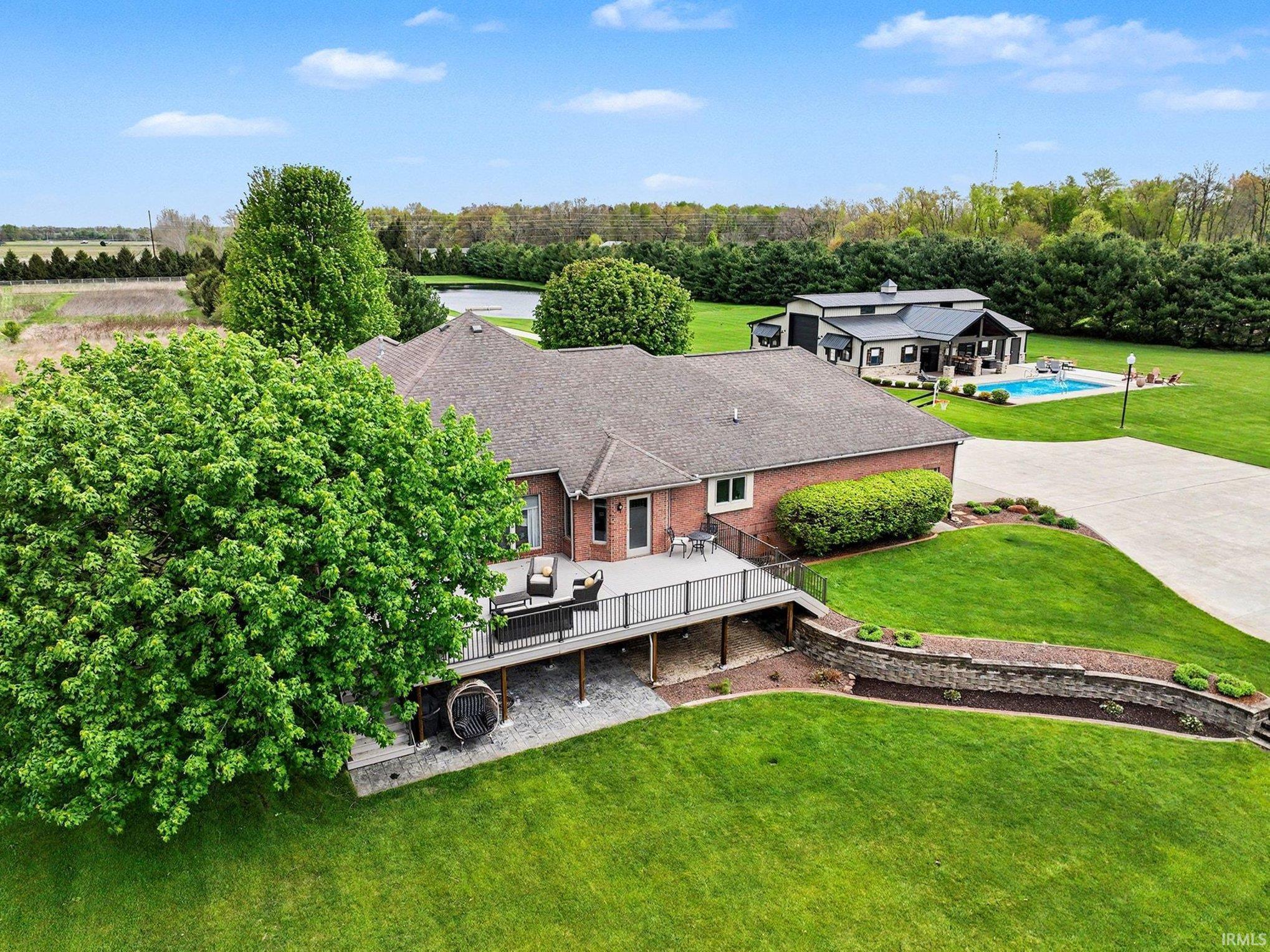 The aerial view showcases the great back yard, deck, and general layout of the buildings
