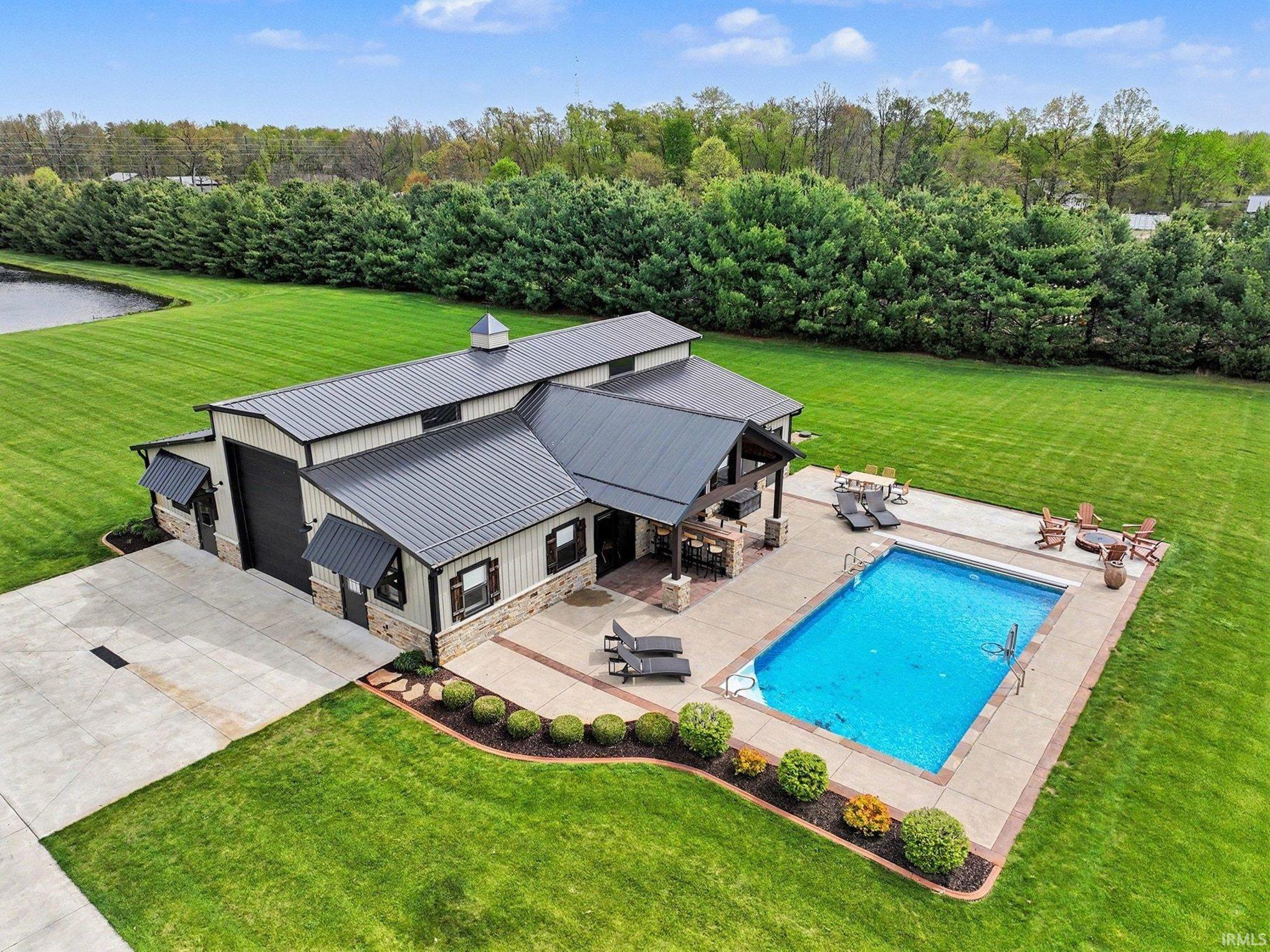 This aerial view shows the updated and manicured pool and shop areas
