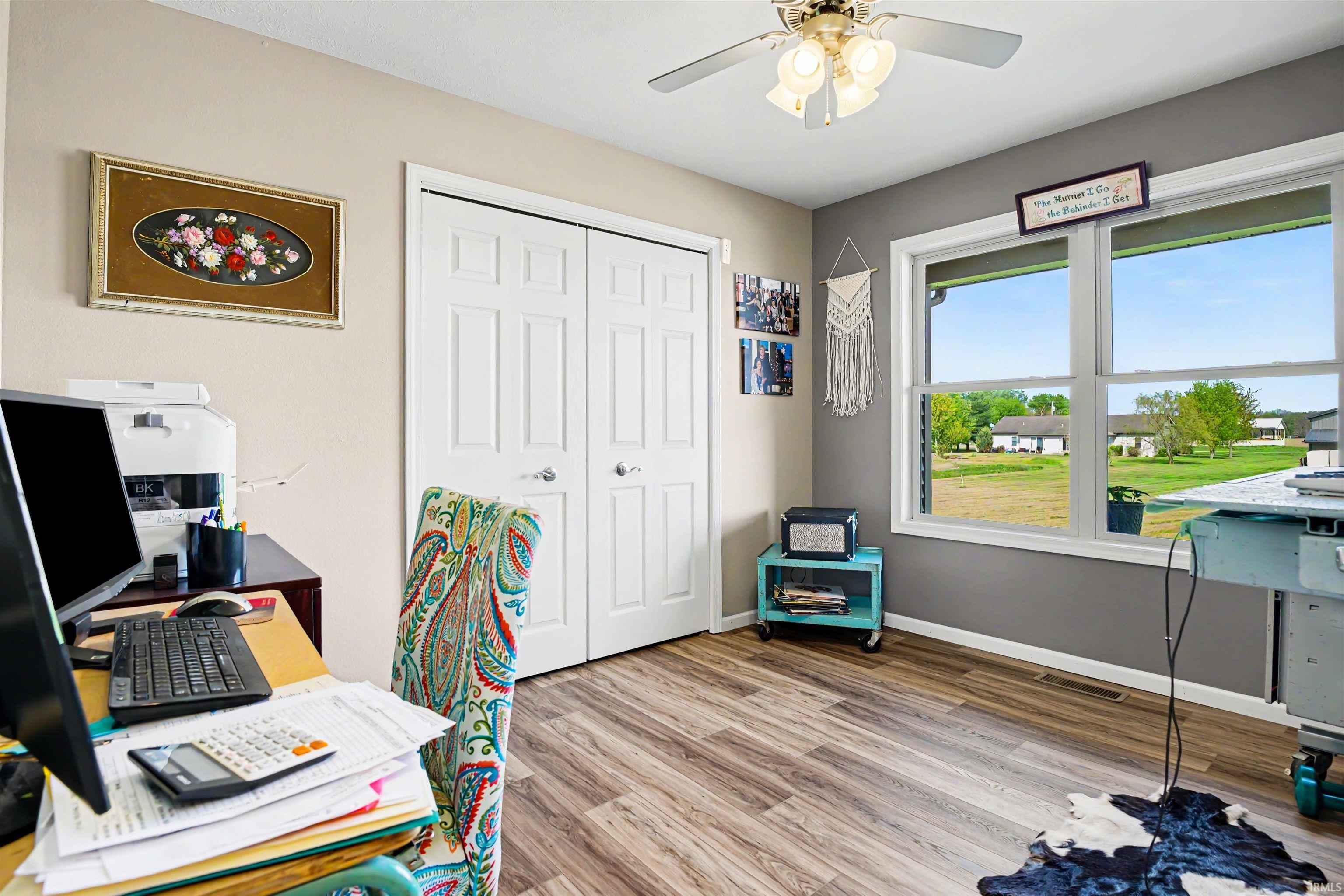 Room featuring wood-finish flooring and great natural light