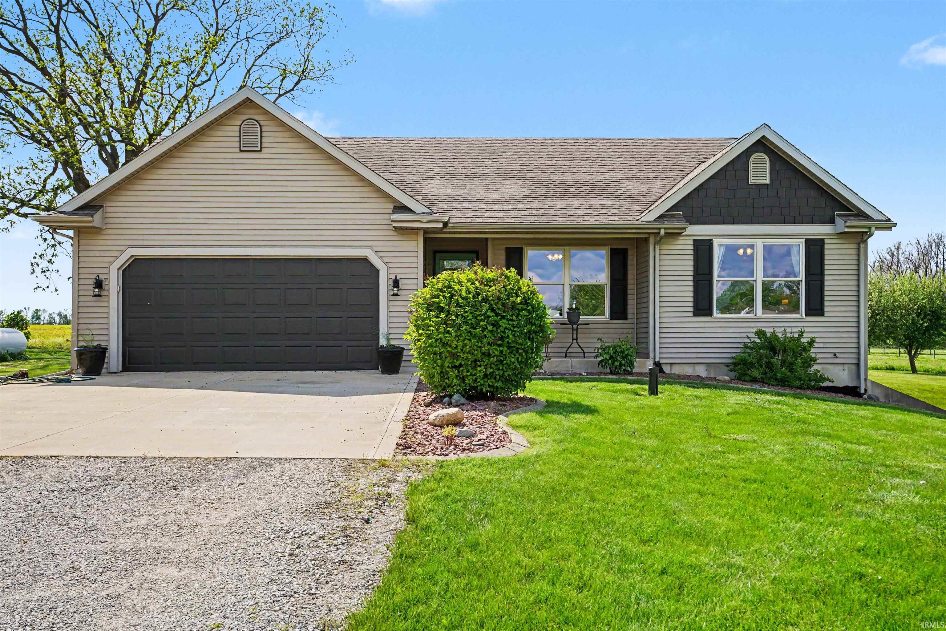 Ranch-style exterior with light-toned siding and a dark shingle roof