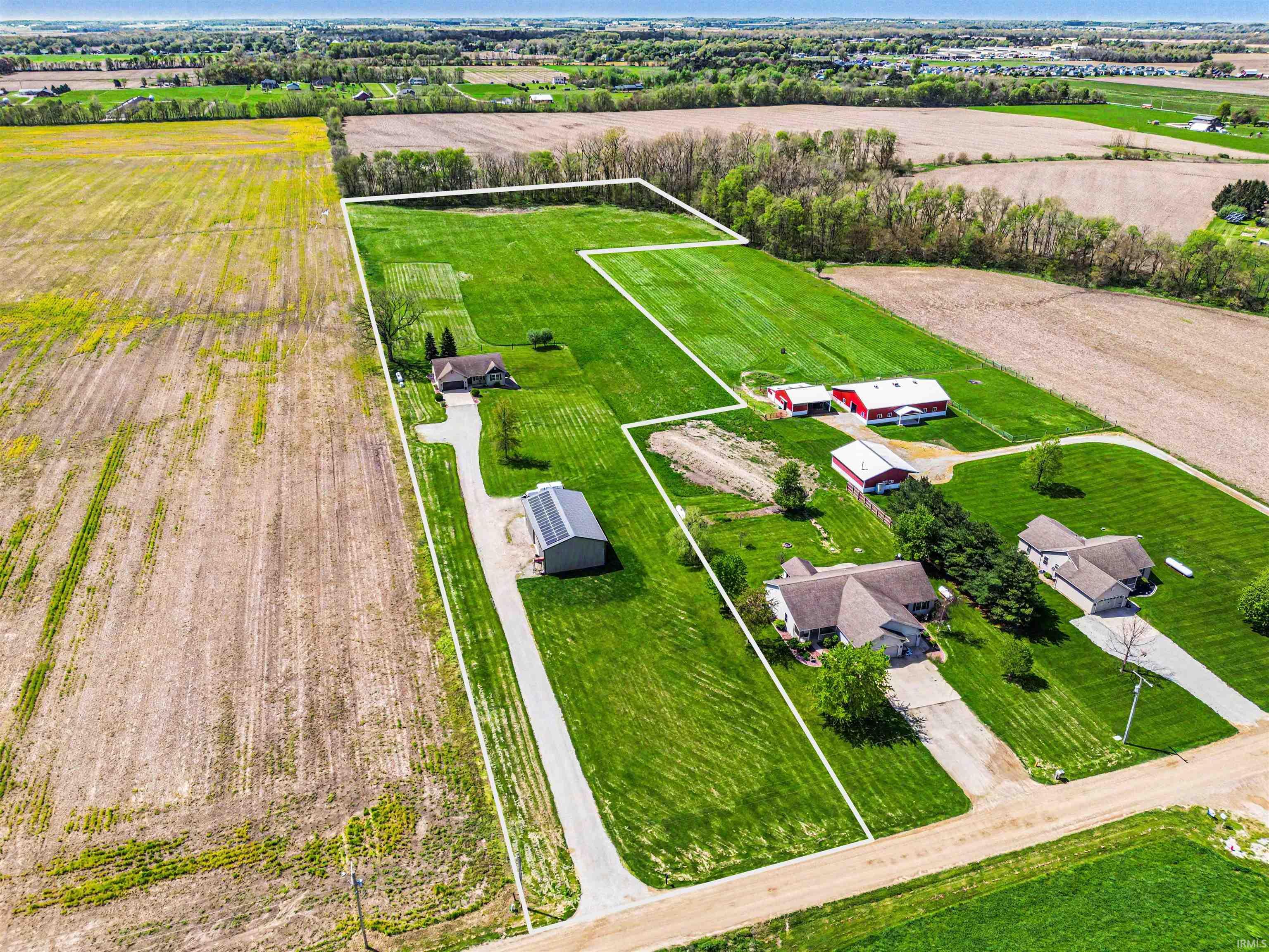 Expansive rural property featuring multiple residential structures and agricultural land