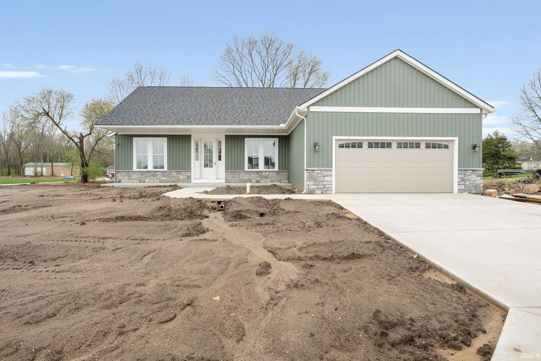Contemporary ranch-style residence featuring vertical siding, stone accents, and a dark shingle roof
