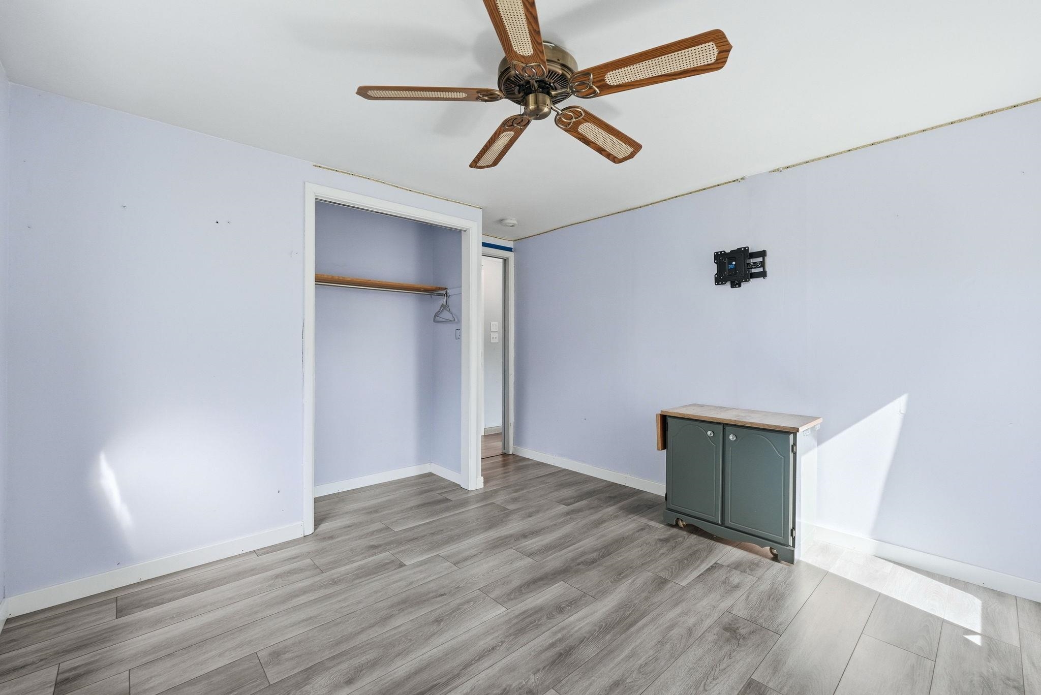 Light-toned wood-finish flooring complements the pastel wall tones