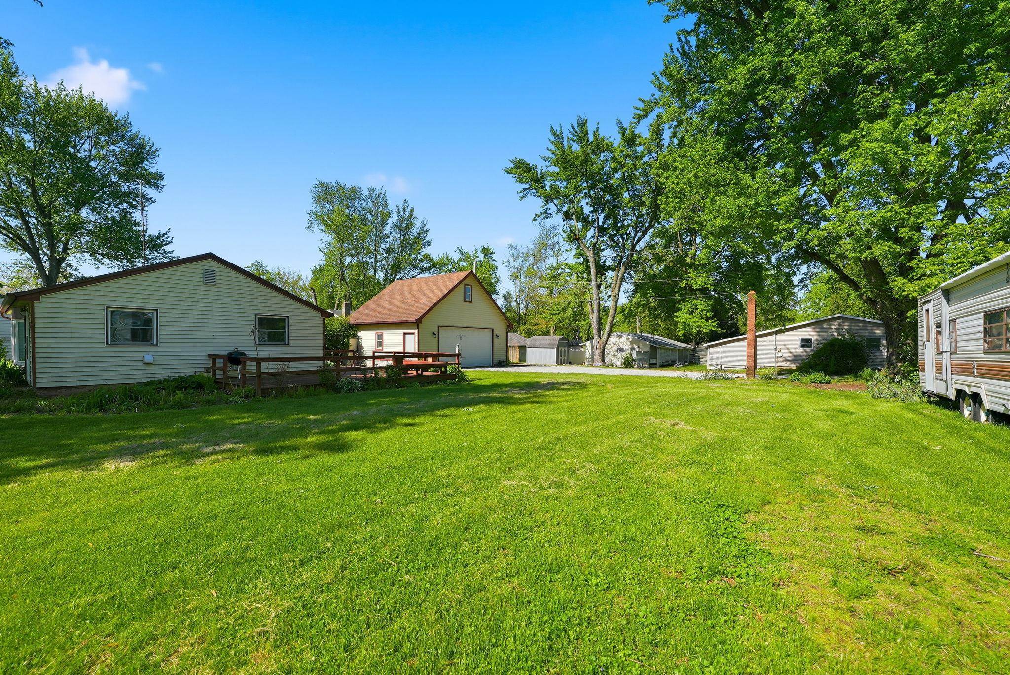 Expansive green lawn with mature trees, offering a broad outdoor space