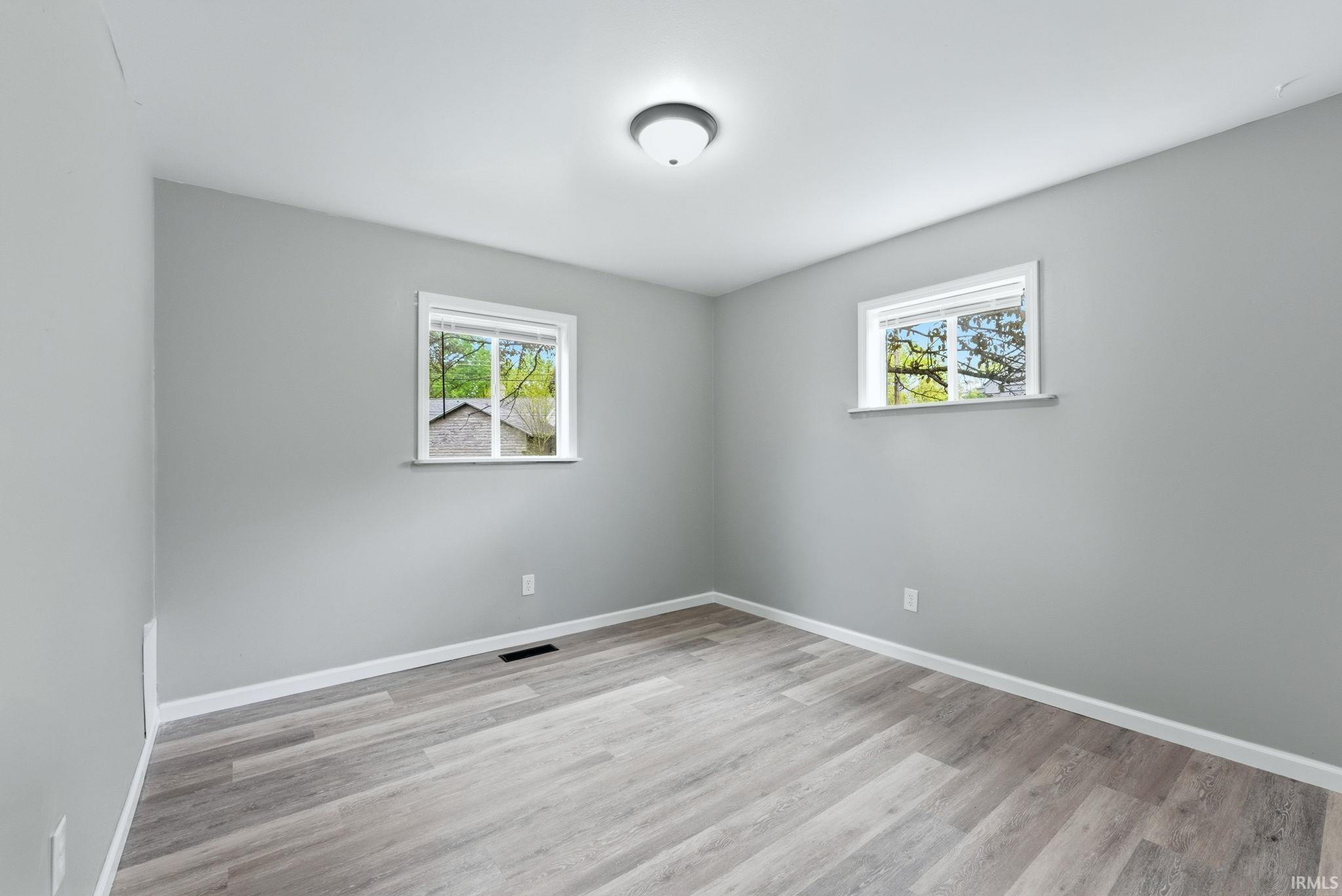 Neutral gray walls complemented by wood-finish flooring