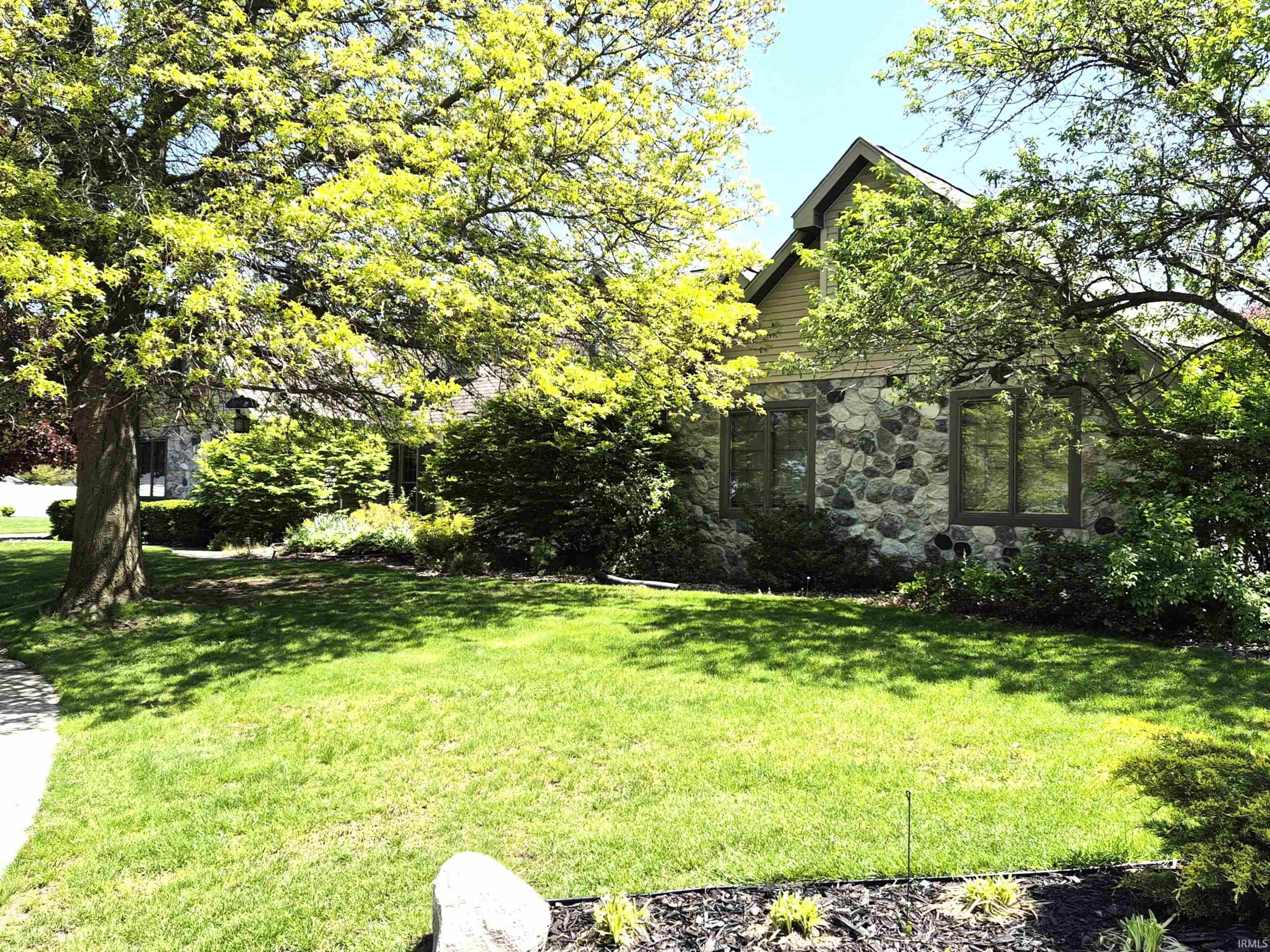 Stone veneer exterior with multiple window configurations
