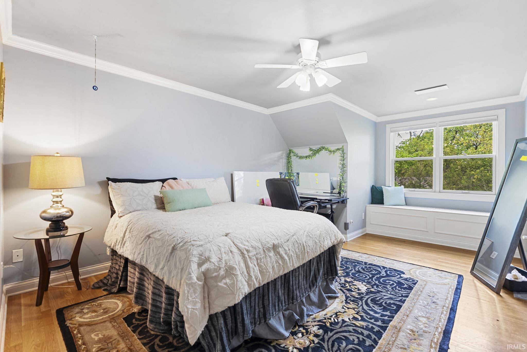 Hardwood-style flooring throughout this room with a white ceiling fan light fixture