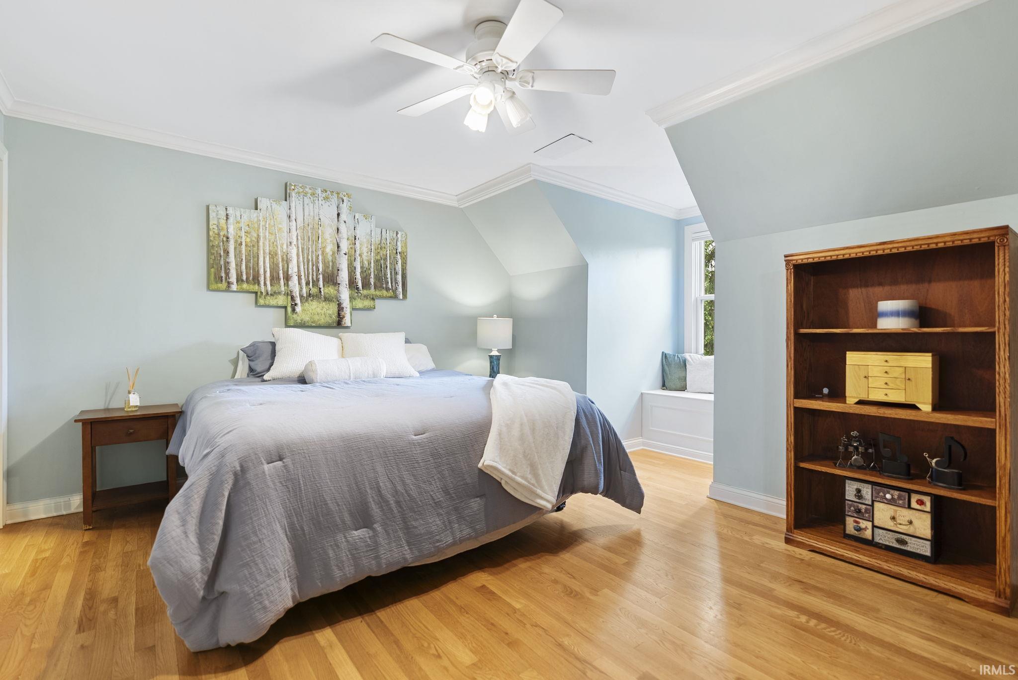 Hardwood flooring, crown molding, and a built-in window seat