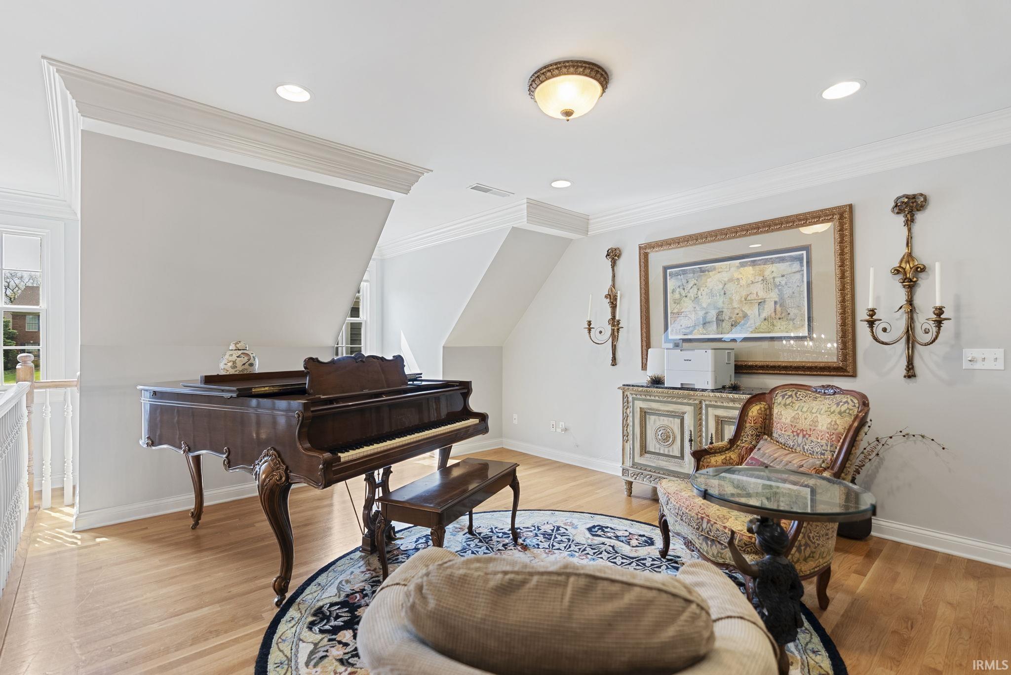 Hardwood flooring featuring an elegant decorative area rug