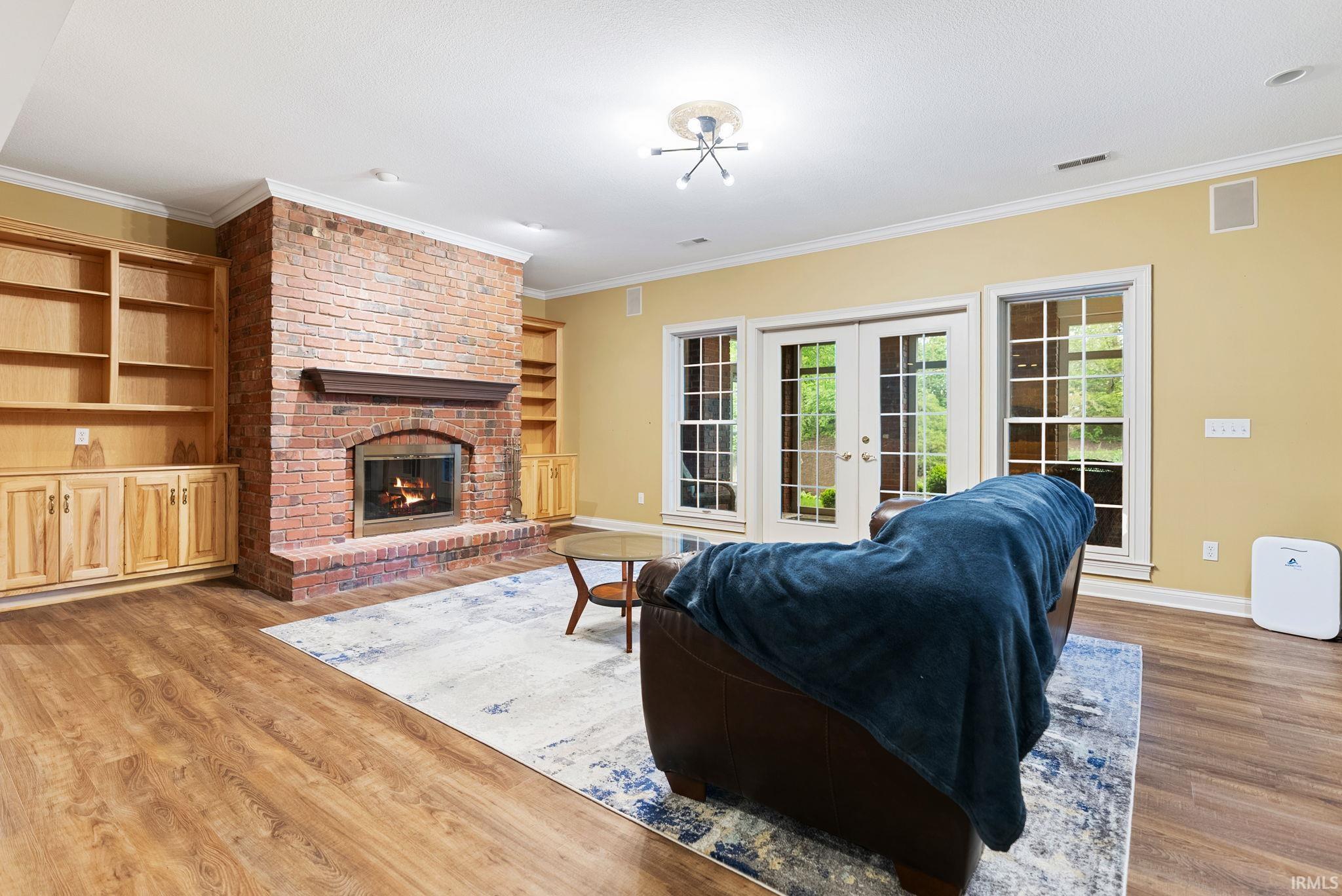 Brick fireplace with wood mantel and hearth