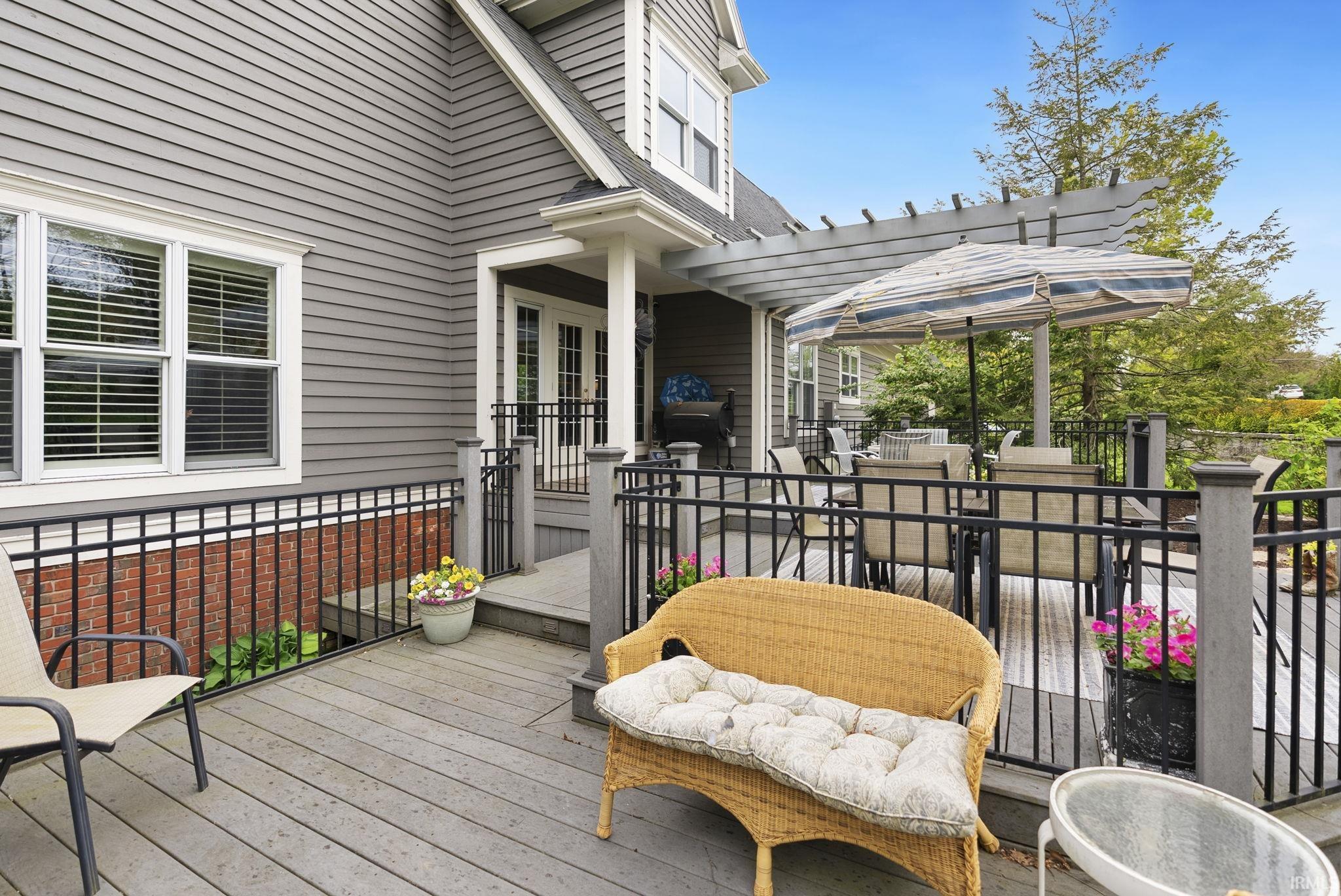 Multi-level exterior deck featuring composite decking and black metal railings