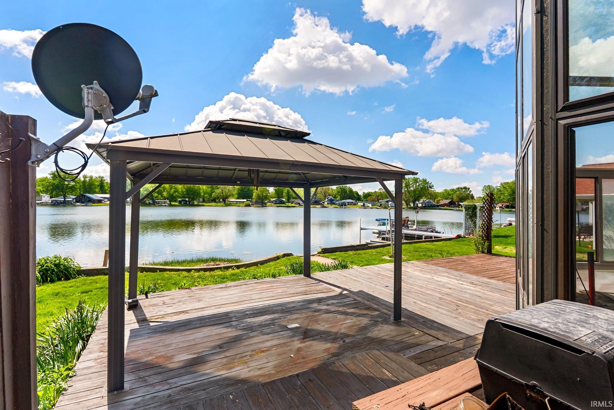 Expansive wood-finish deck featuring a permanent gazebo structure