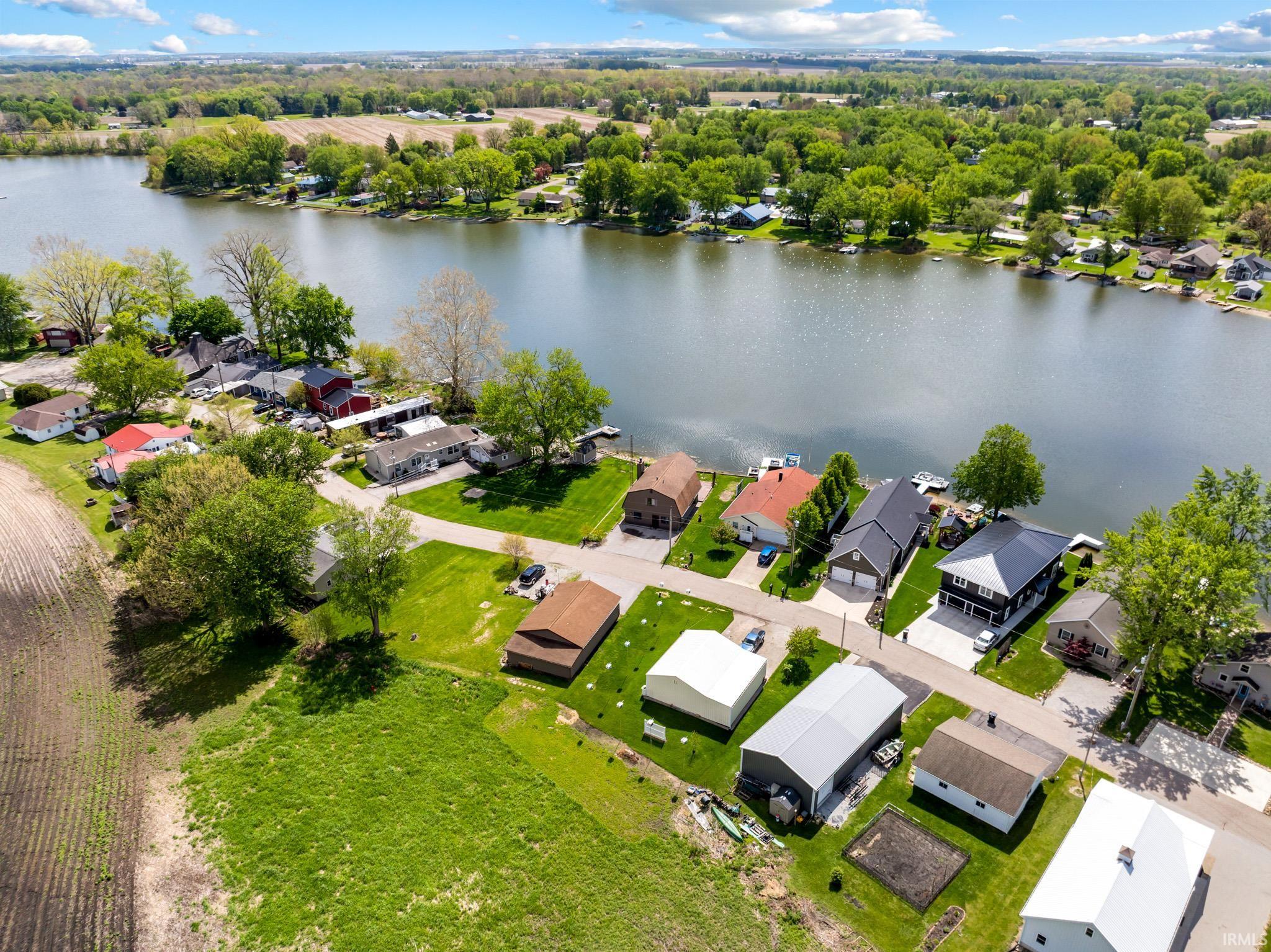 Aerial perspective highlighting waterfront properties along a serene body of water