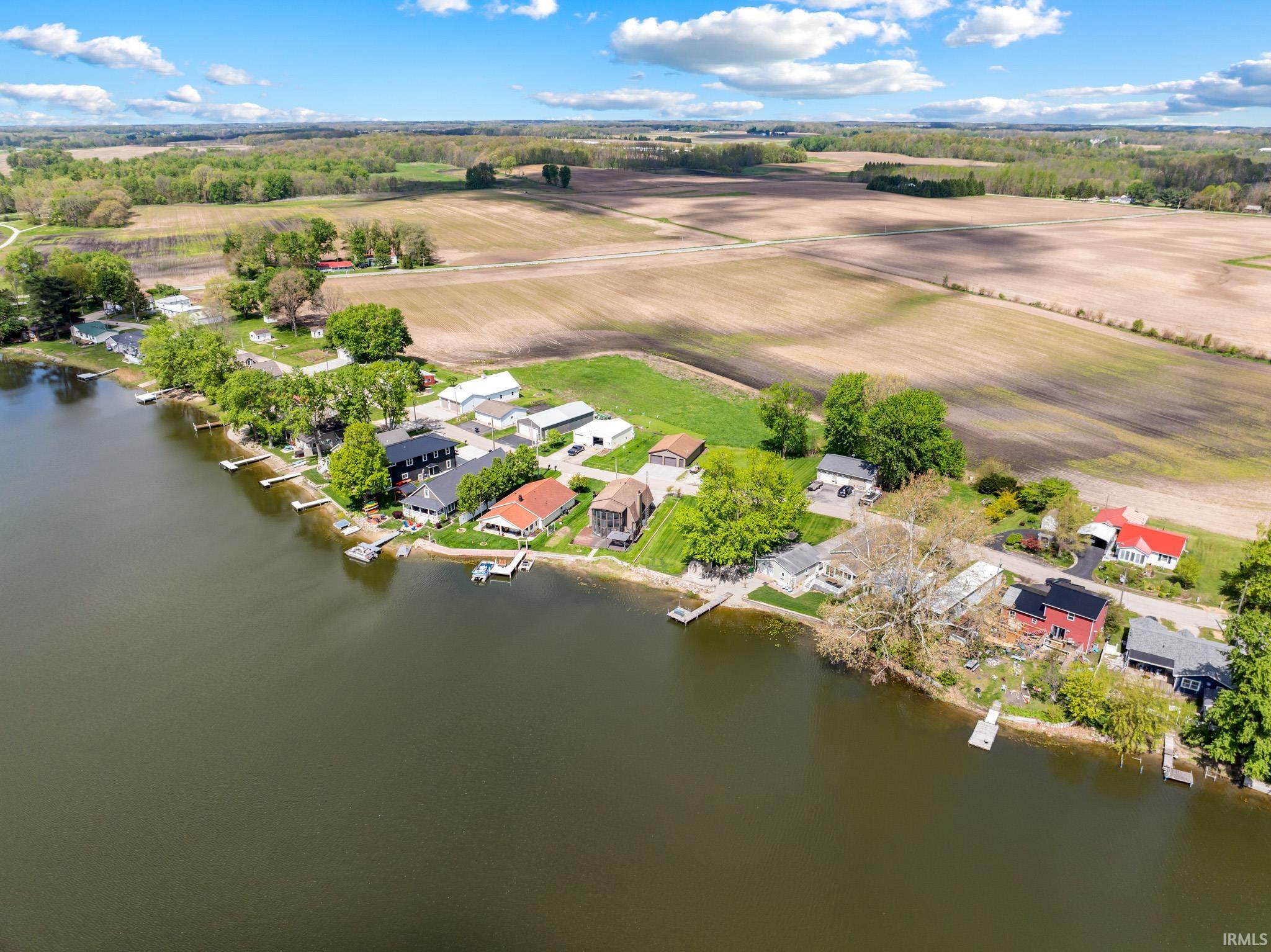 Aerial perspective of a lakeside community featuring residential properties with private docks
