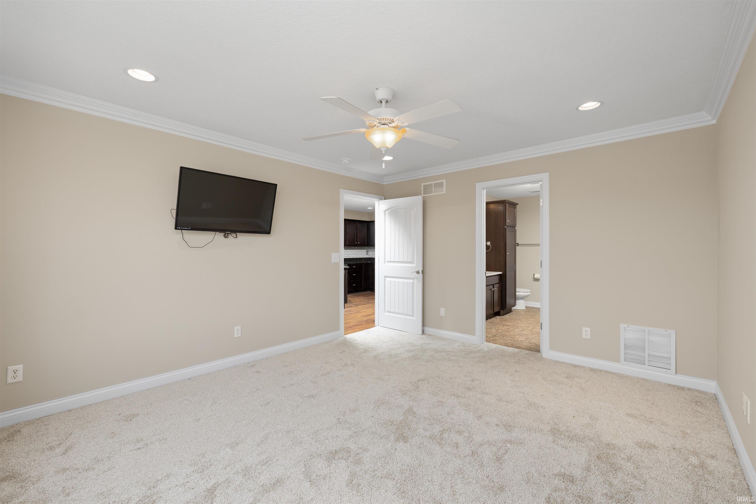 Spacious room featuring neutral carpeting and light-colored walls