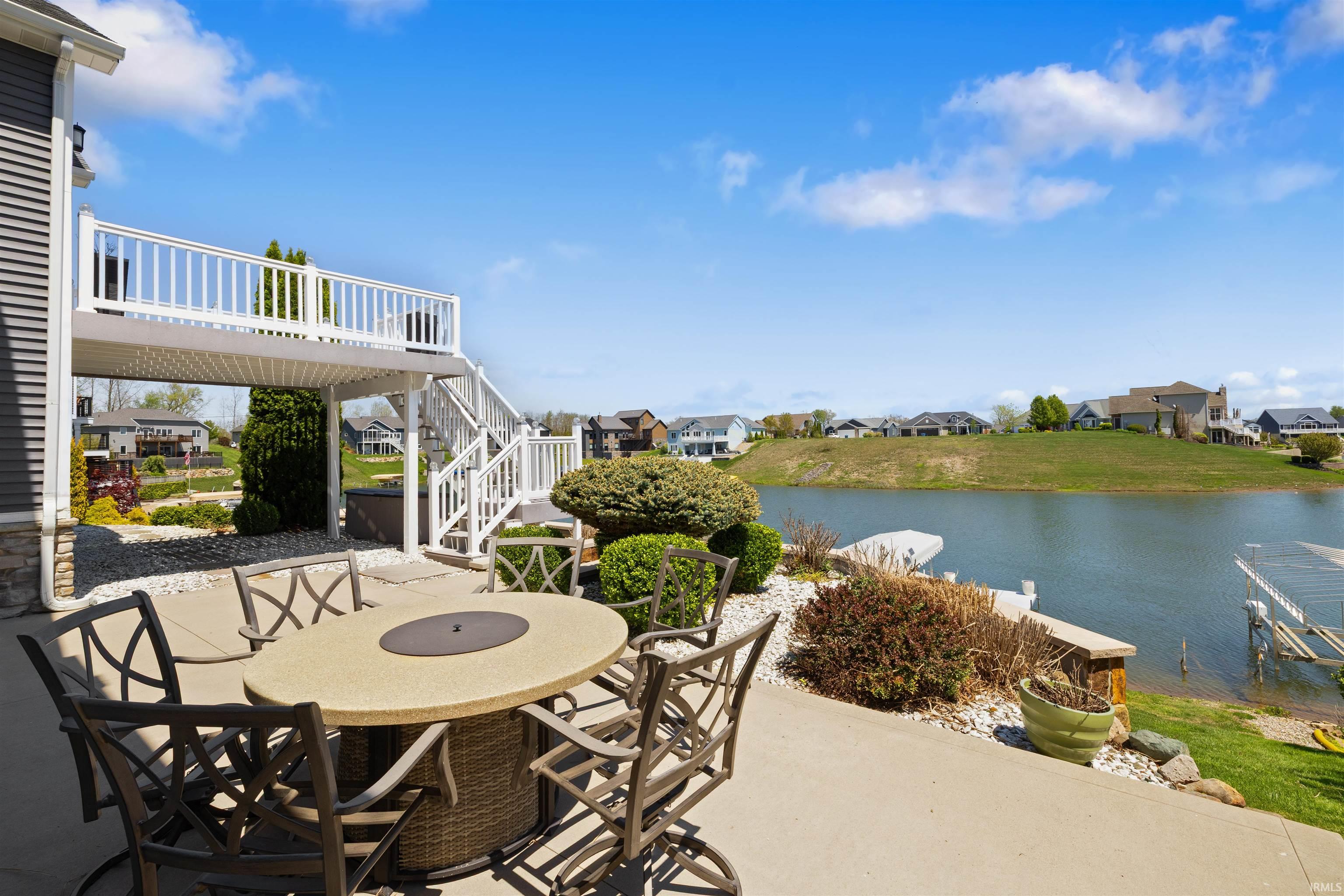 Concrete patio with lake access and a private dock