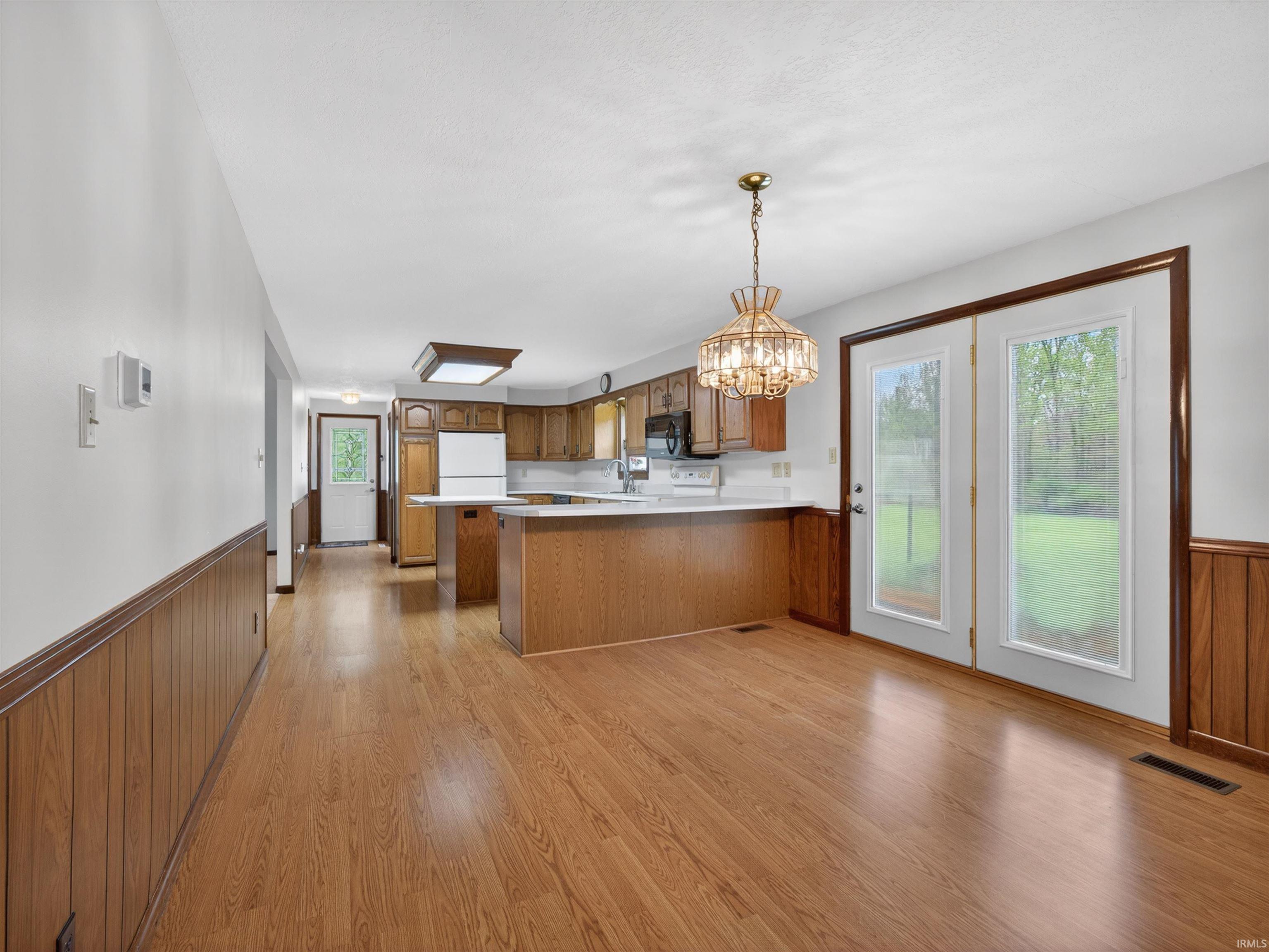 Open concept kitchen and dining area with wood-finish flooring