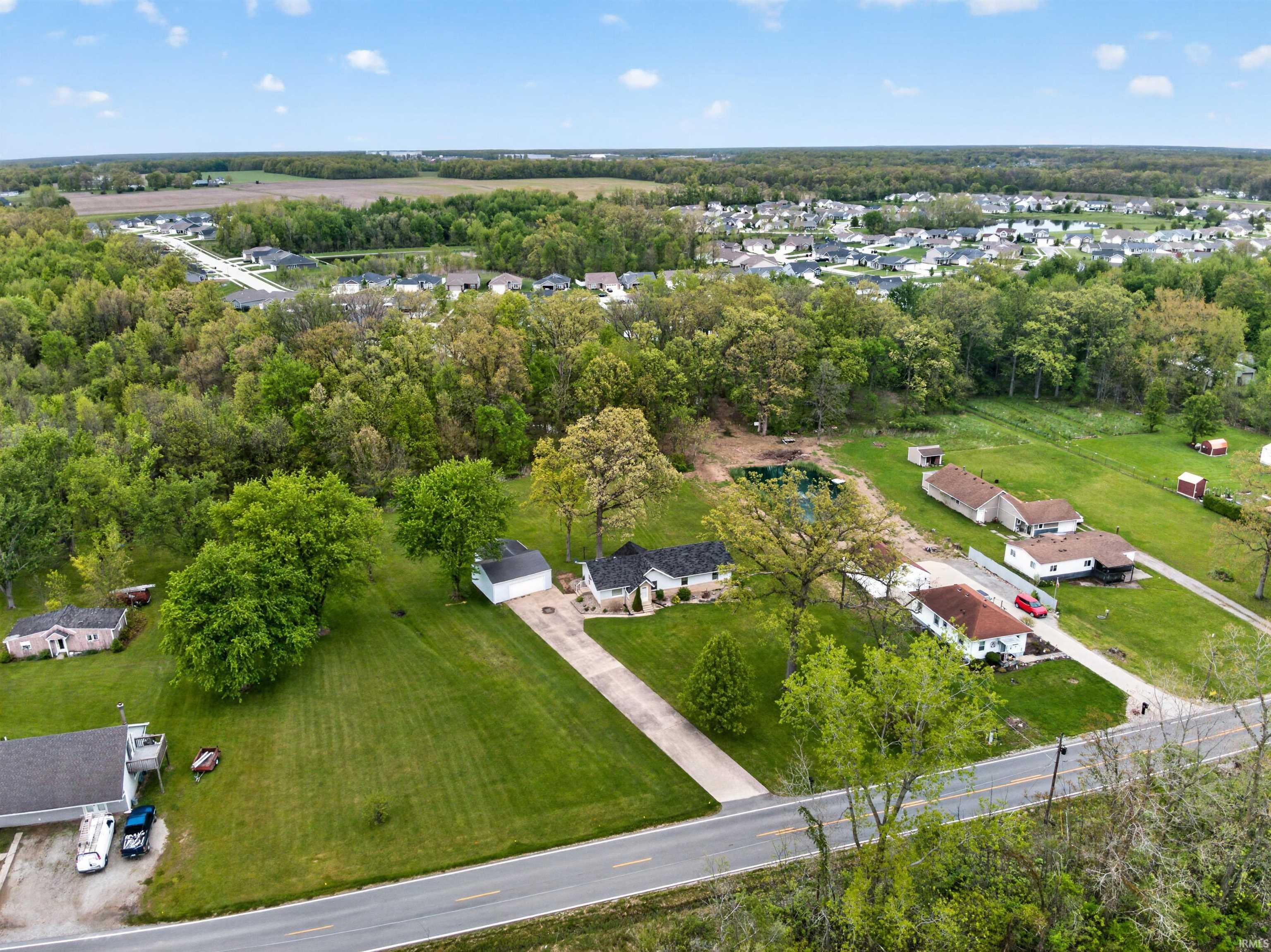 Expansive property featuring a single-story residence with a detached garage
