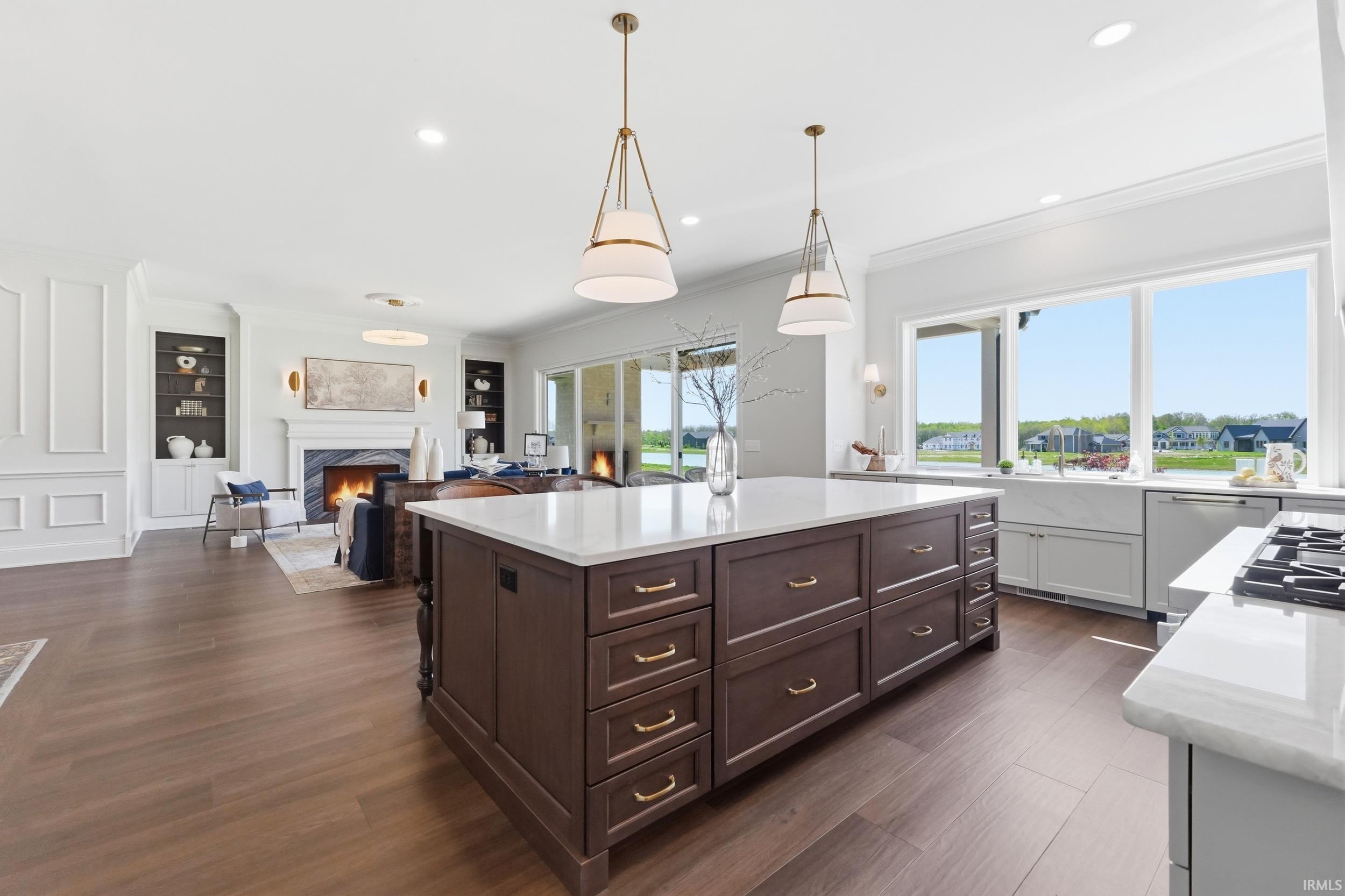 Expansive kitchen island with dark wood-finish cabinetry, ample storage, and a light-colored countertop