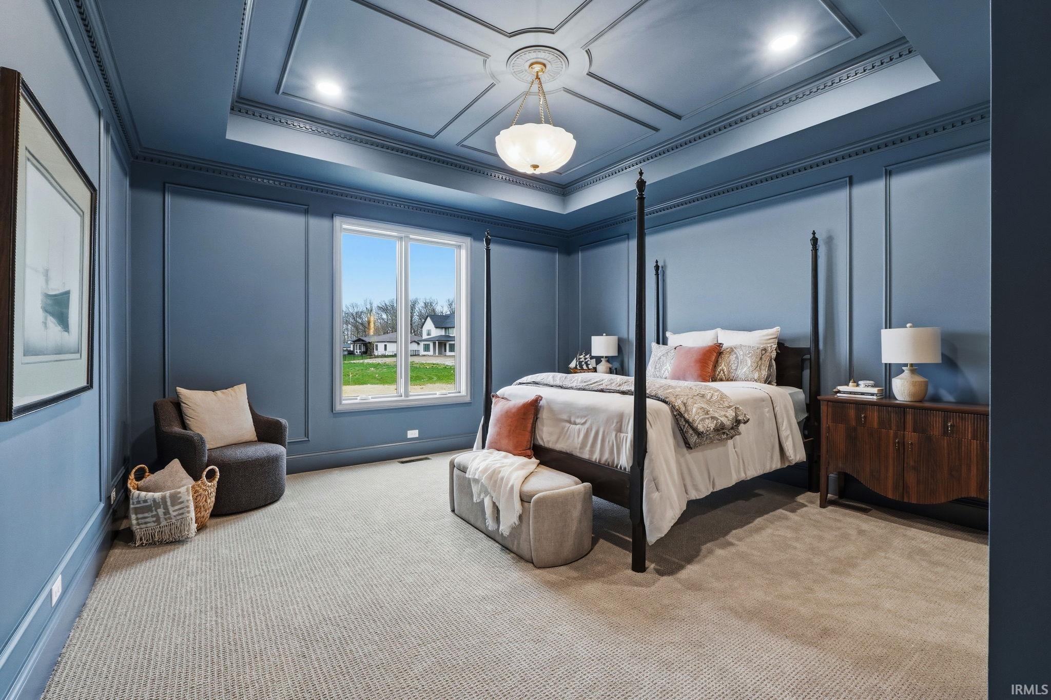 Room featuring a coffered ceiling with a central chandelier, decorative crown molding, and wall paneling