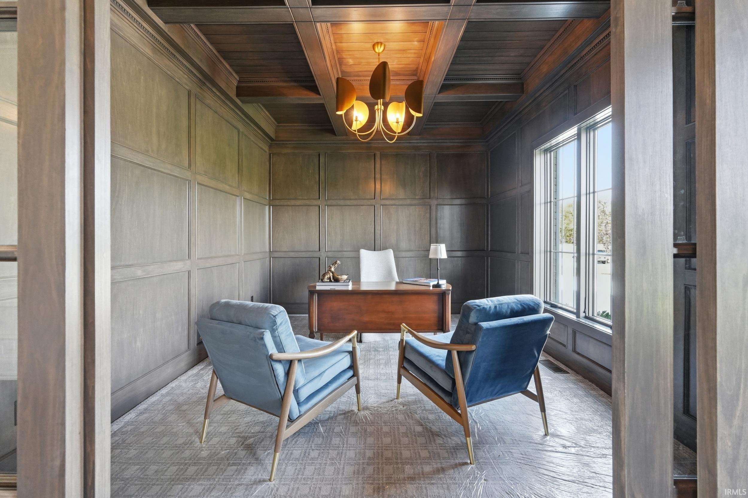 Paneled walls and a coffered ceiling define this interior space