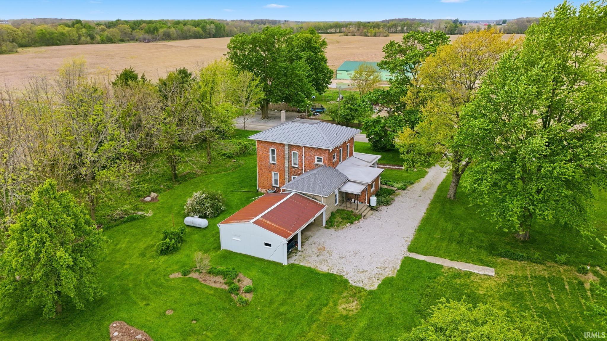 Historic brick residence featuring multiple additions and a metal roof