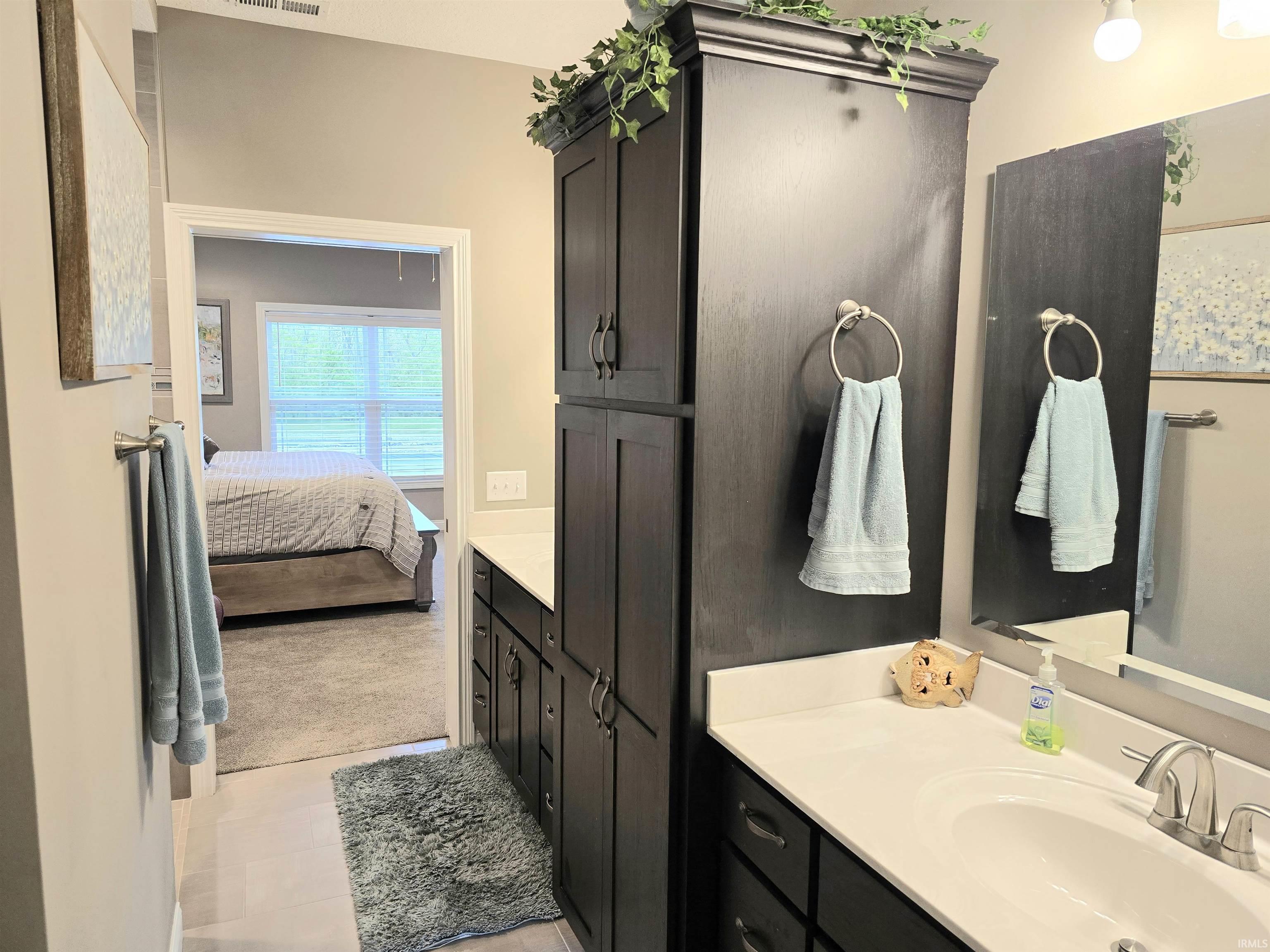 Large Master bath w/tiled walk in shower that offers a rain head shower, double vanity, linen cabinet, and private toilet. Direct access from the bath to the master closet and direct access from the closet to the laundry room.