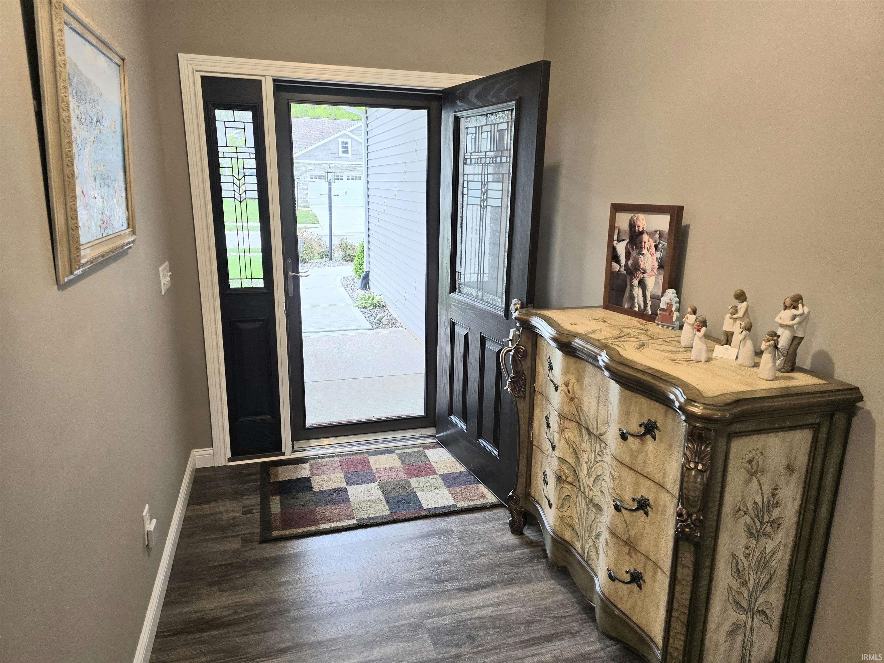 Entryway featuring LVP flooring and neutral wall tones