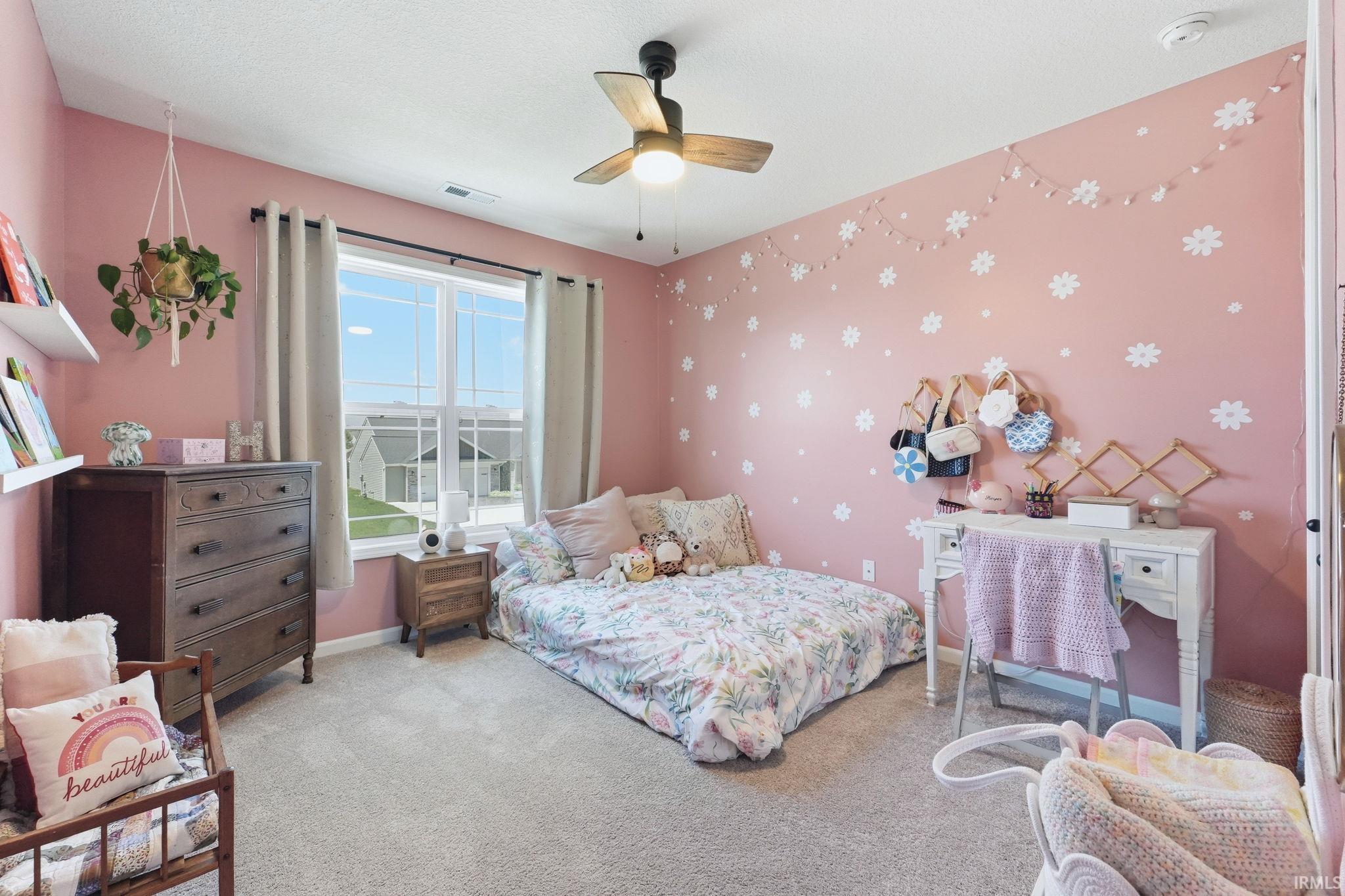 Room featuring light-colored wall-to-wall carpeting and a ceiling fan with integrated lighting