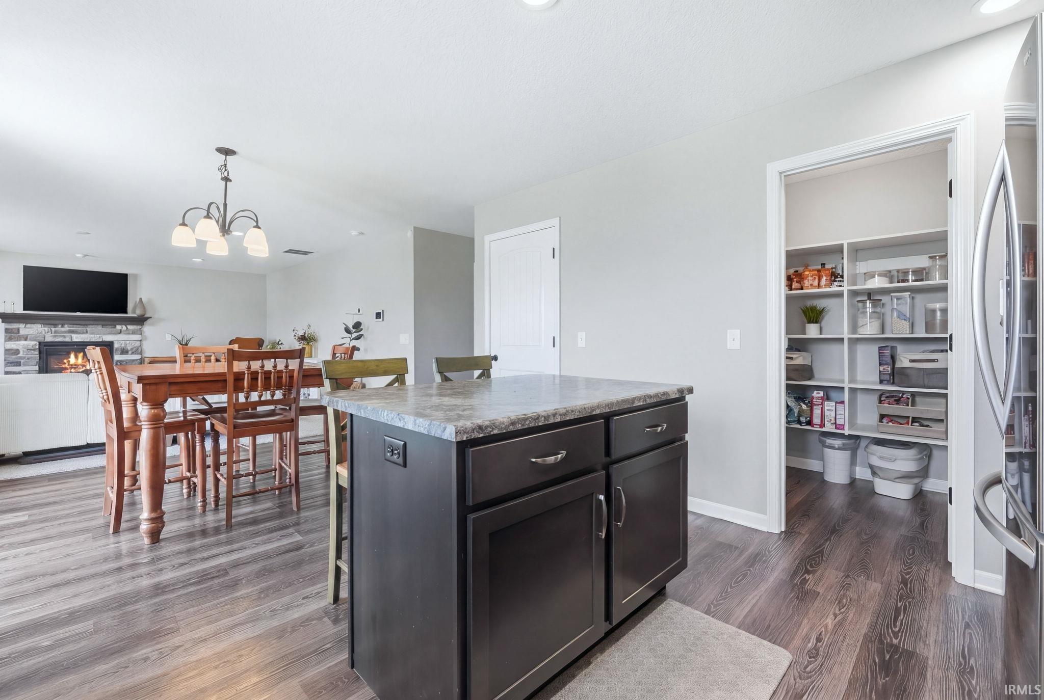 Kitchen island with dark wood-finish cabinetry and light-colored countertop