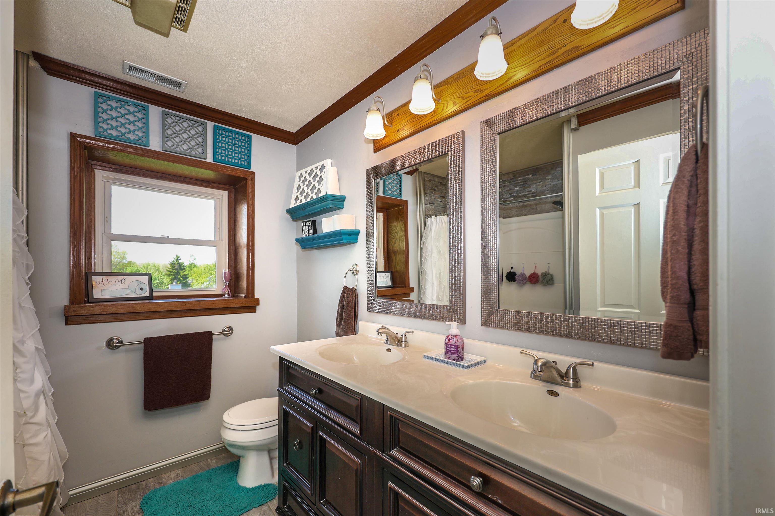 Double vanity with an integrated countertop, dual undermount sinks, and brushed nickel faucets