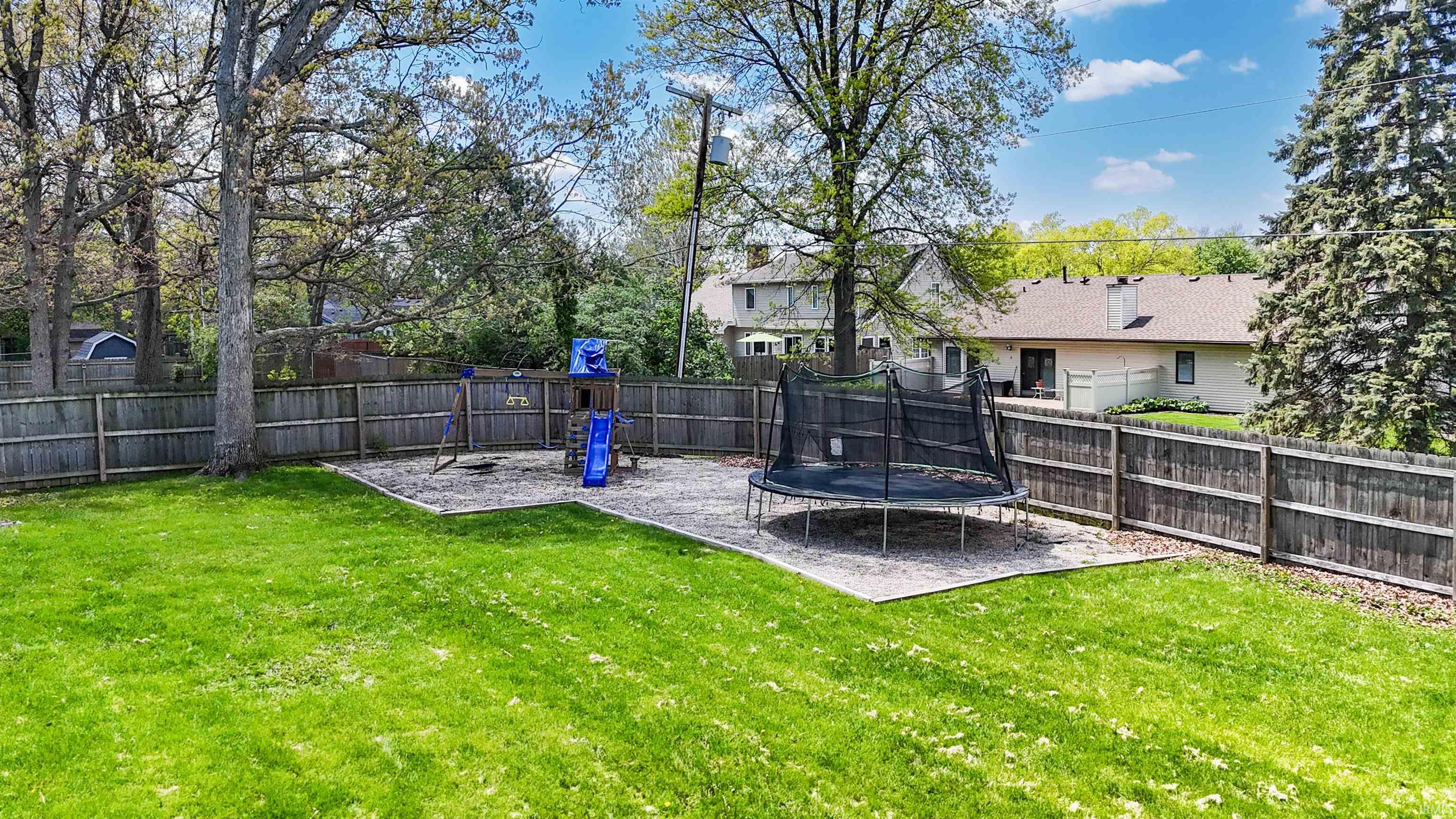 Expansive green lawn framed by a privacy fence