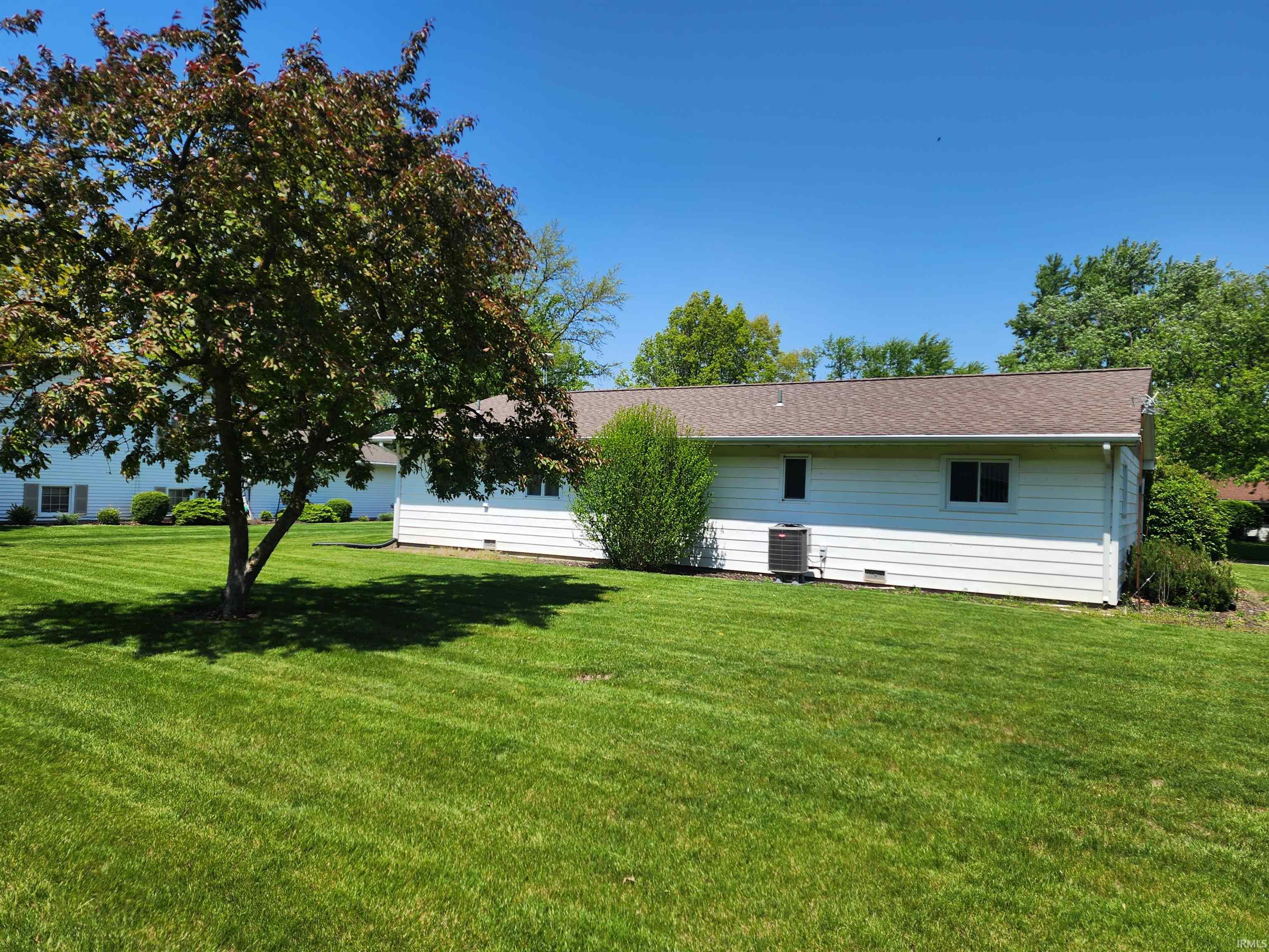 Expansive green lawn with mature shade trees